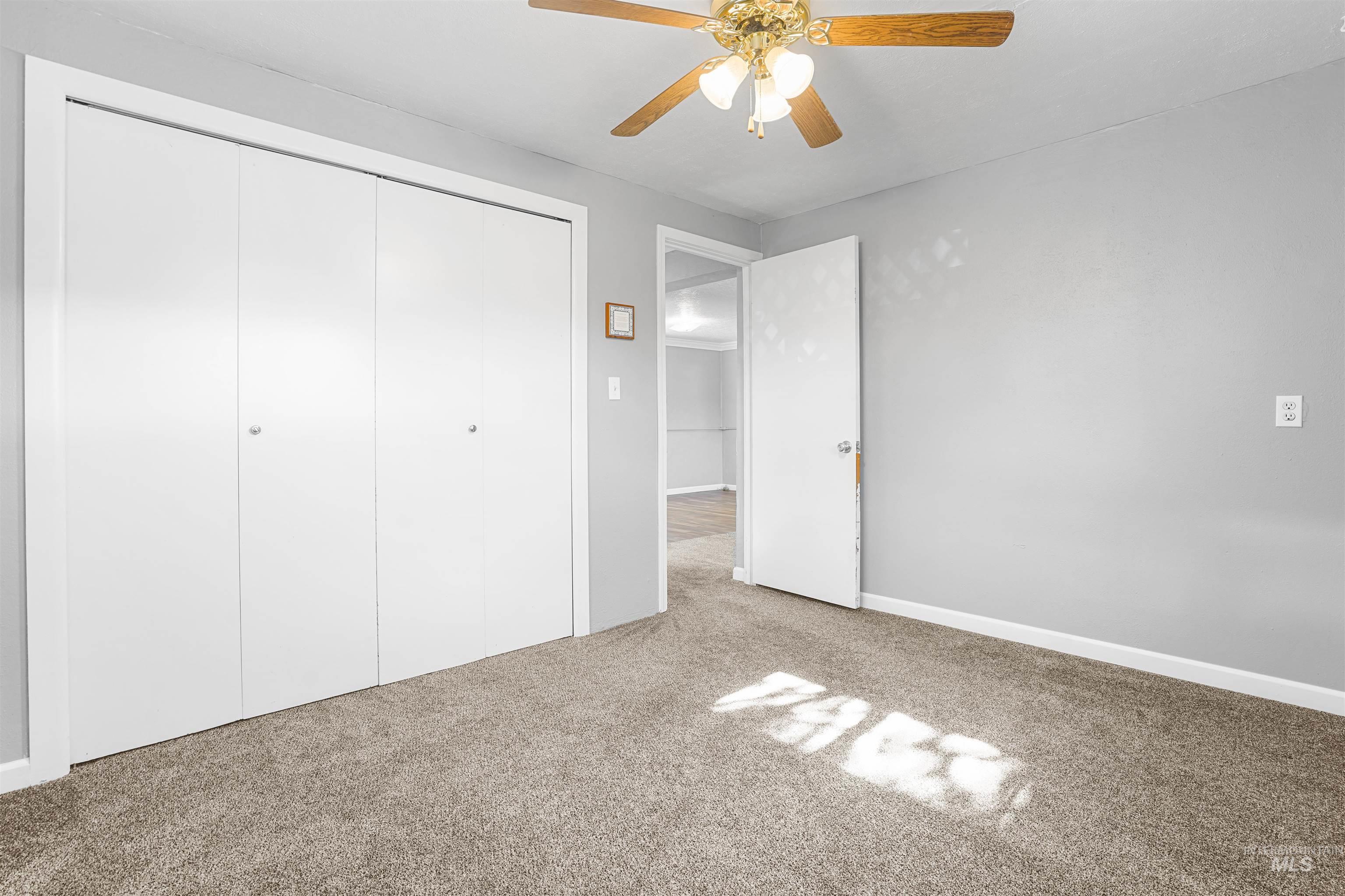 Unfurnished bedroom with carpet floors, a closet, and ceiling fan
