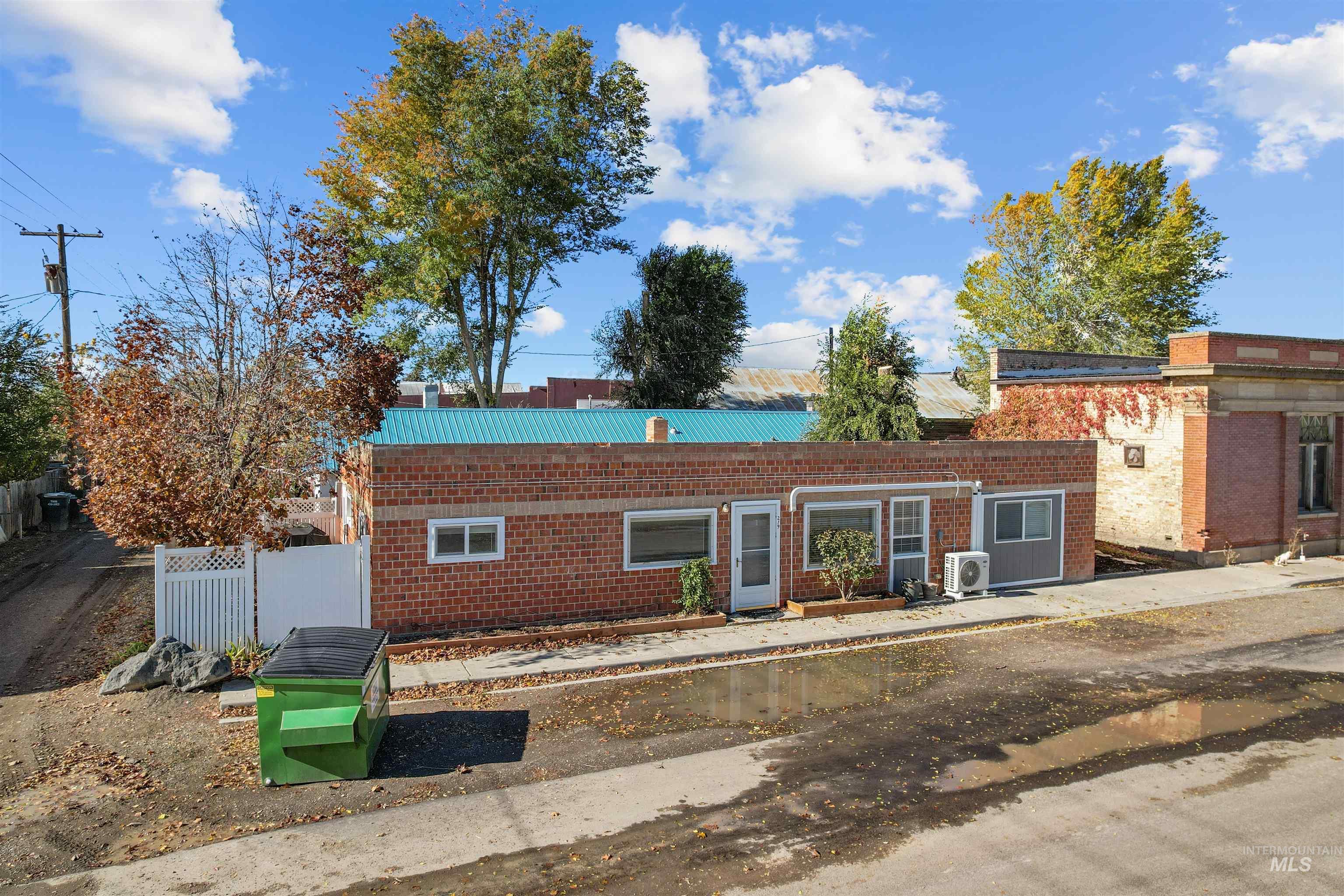 Front facade with a metal roof and brick siding