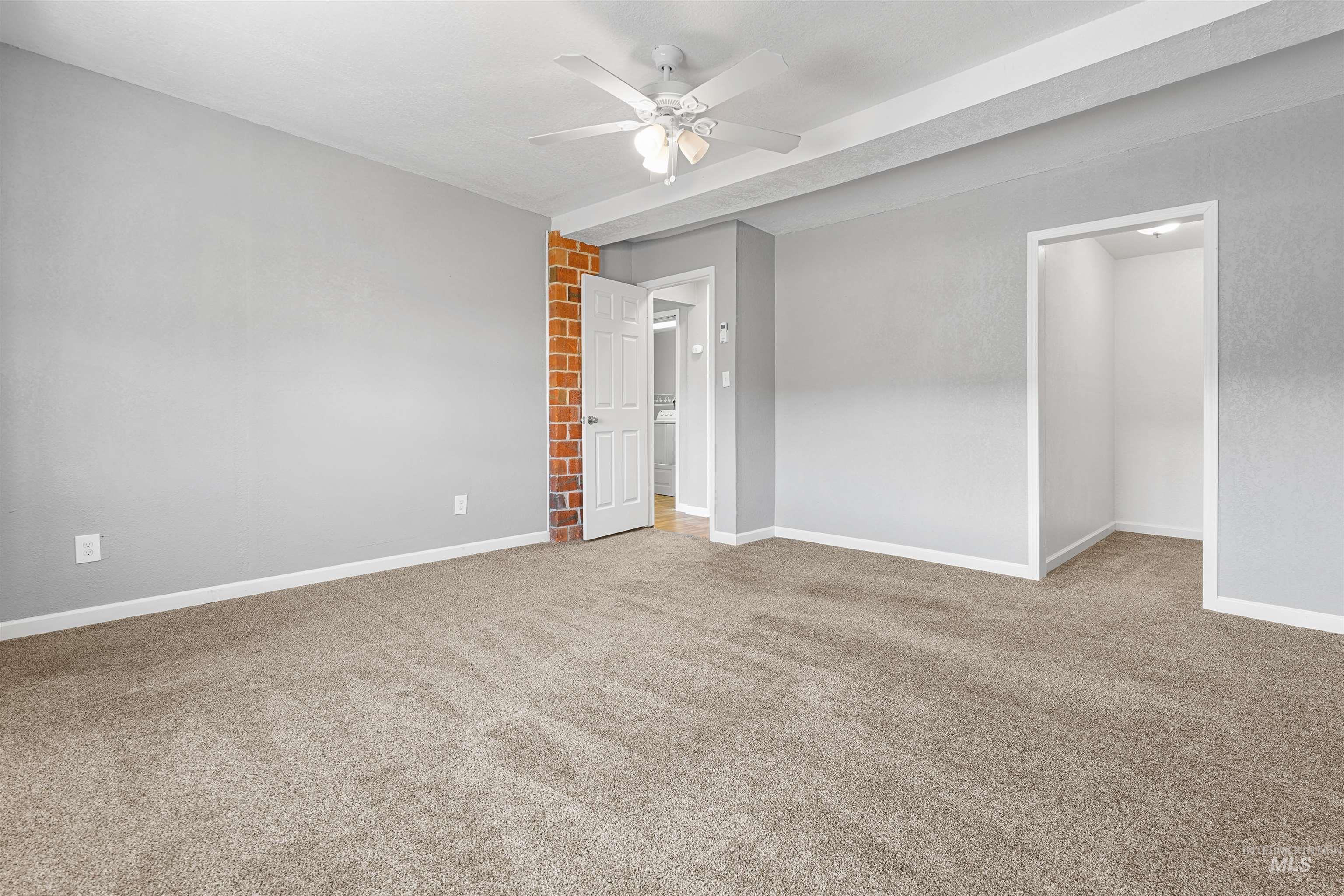 Unfurnished bedroom with light carpet and ceiling fan