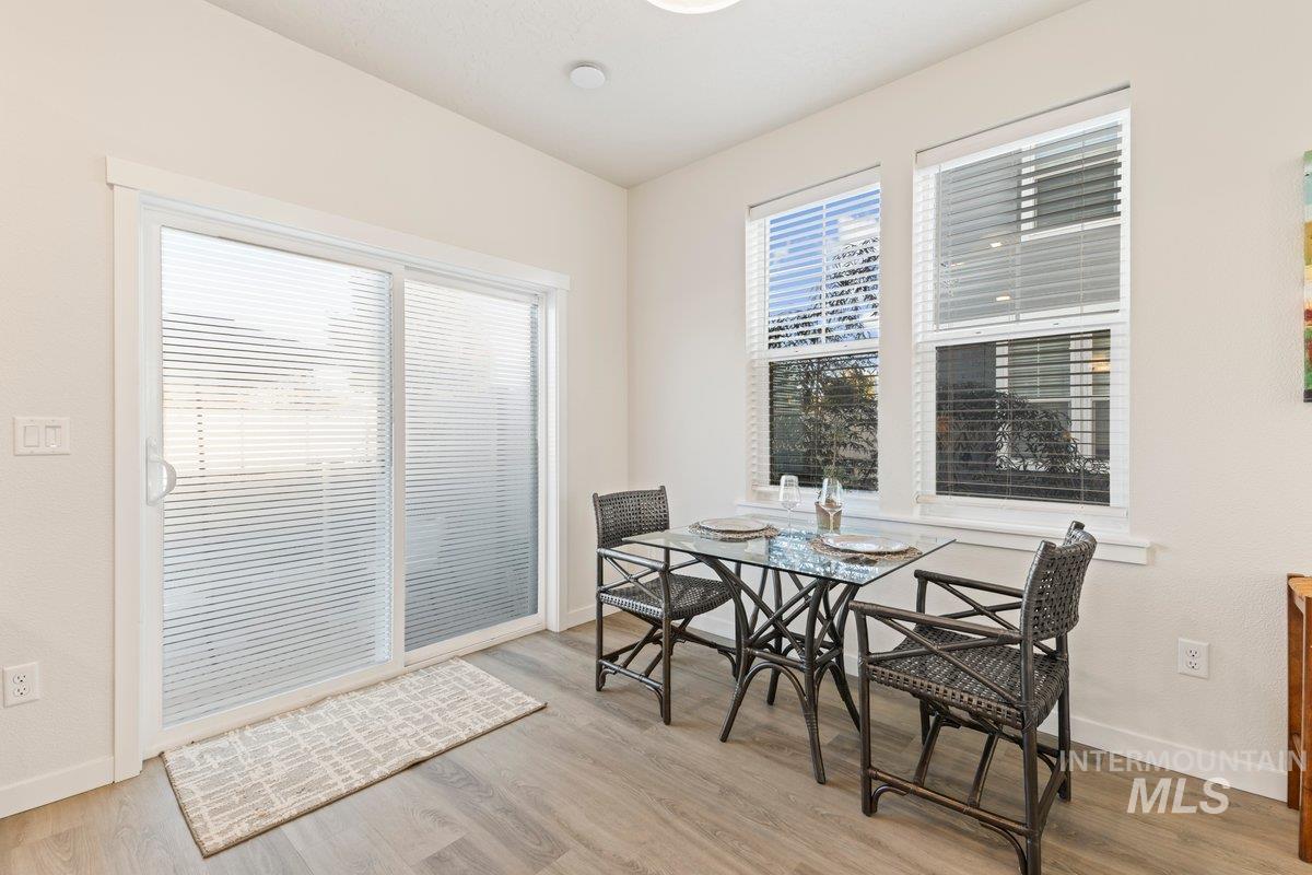 Dining room with light wood finished floors and baseboards