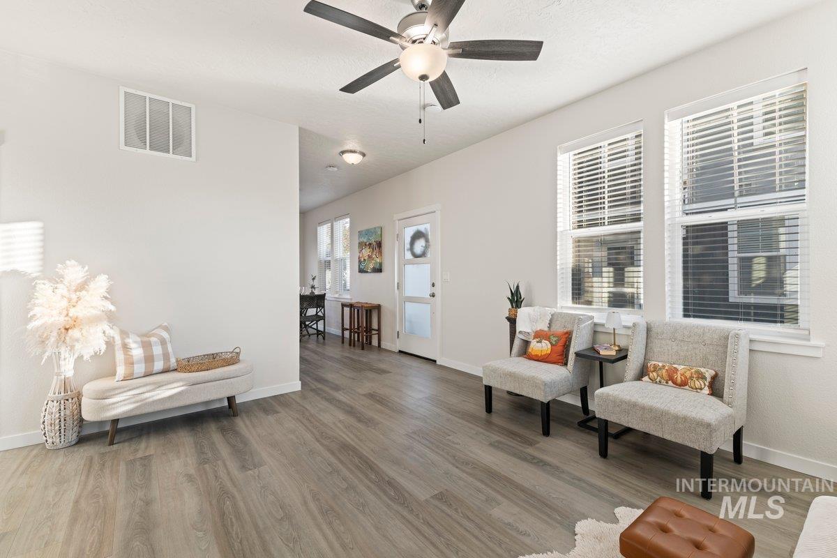 Living area featuring light wood finished floors and ceiling fan