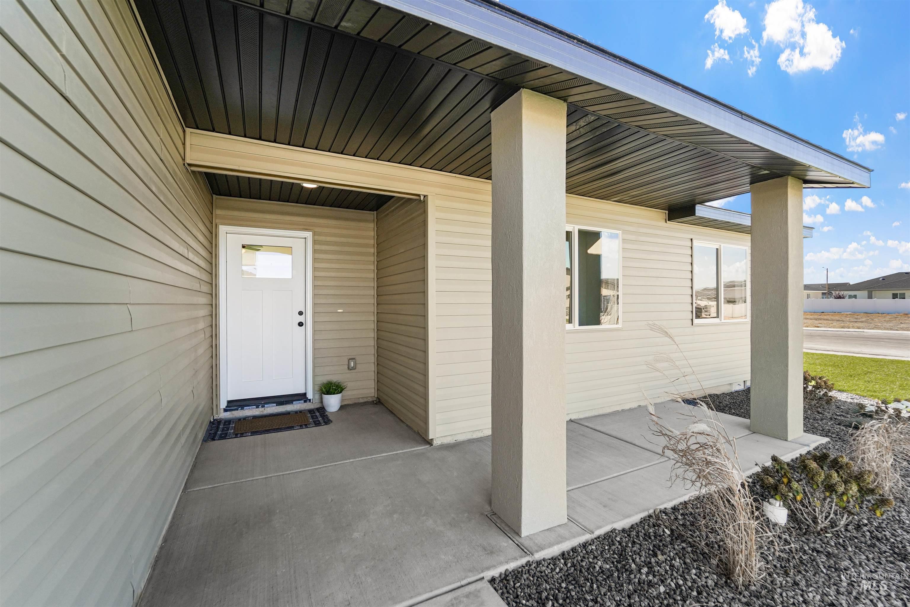 View of exterior entry with covered porch