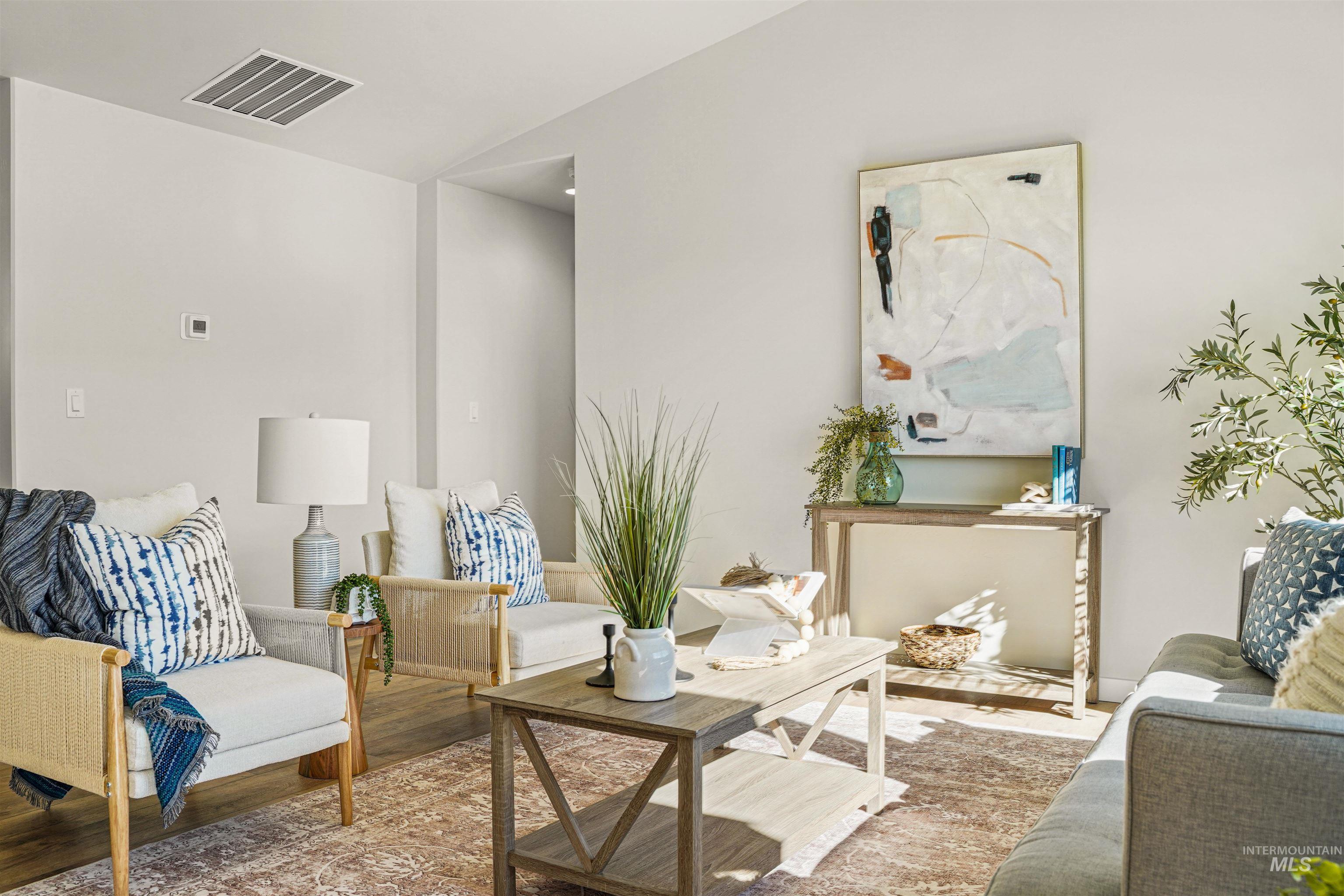 Sitting room featuring wood finished floors and lofted ceiling