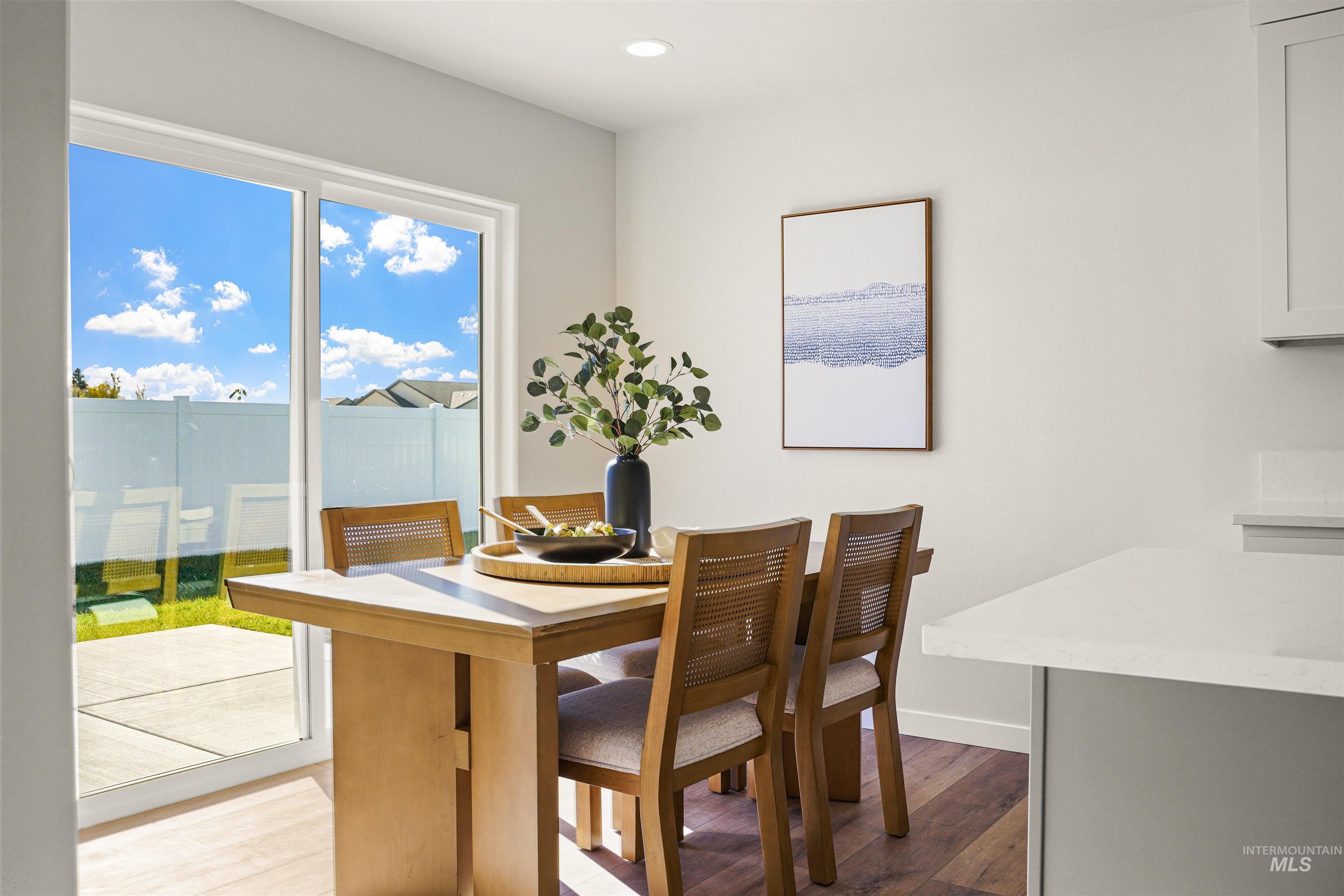 Dining room with light wood-style flooring and recessed lighting
