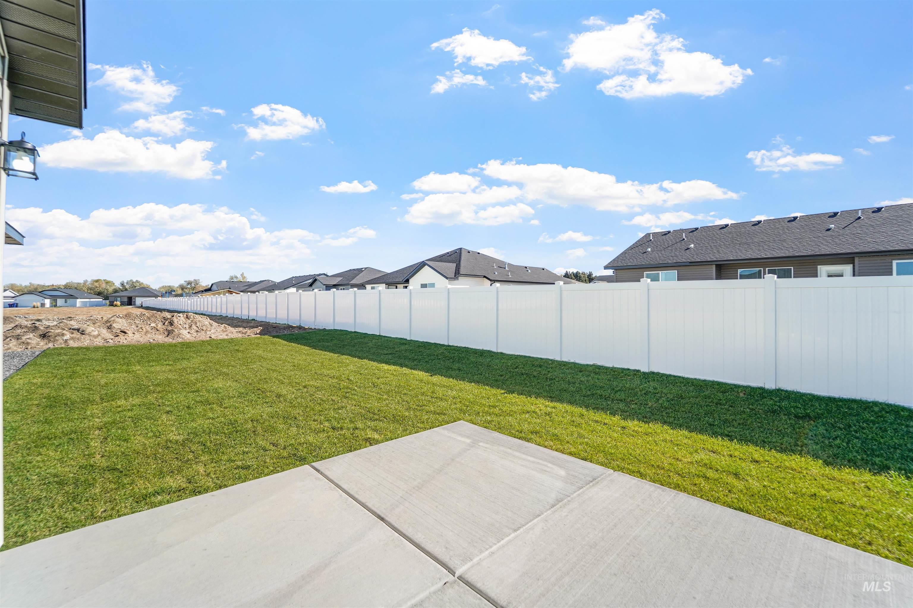 Fenced backyard featuring a residential view and a patio area