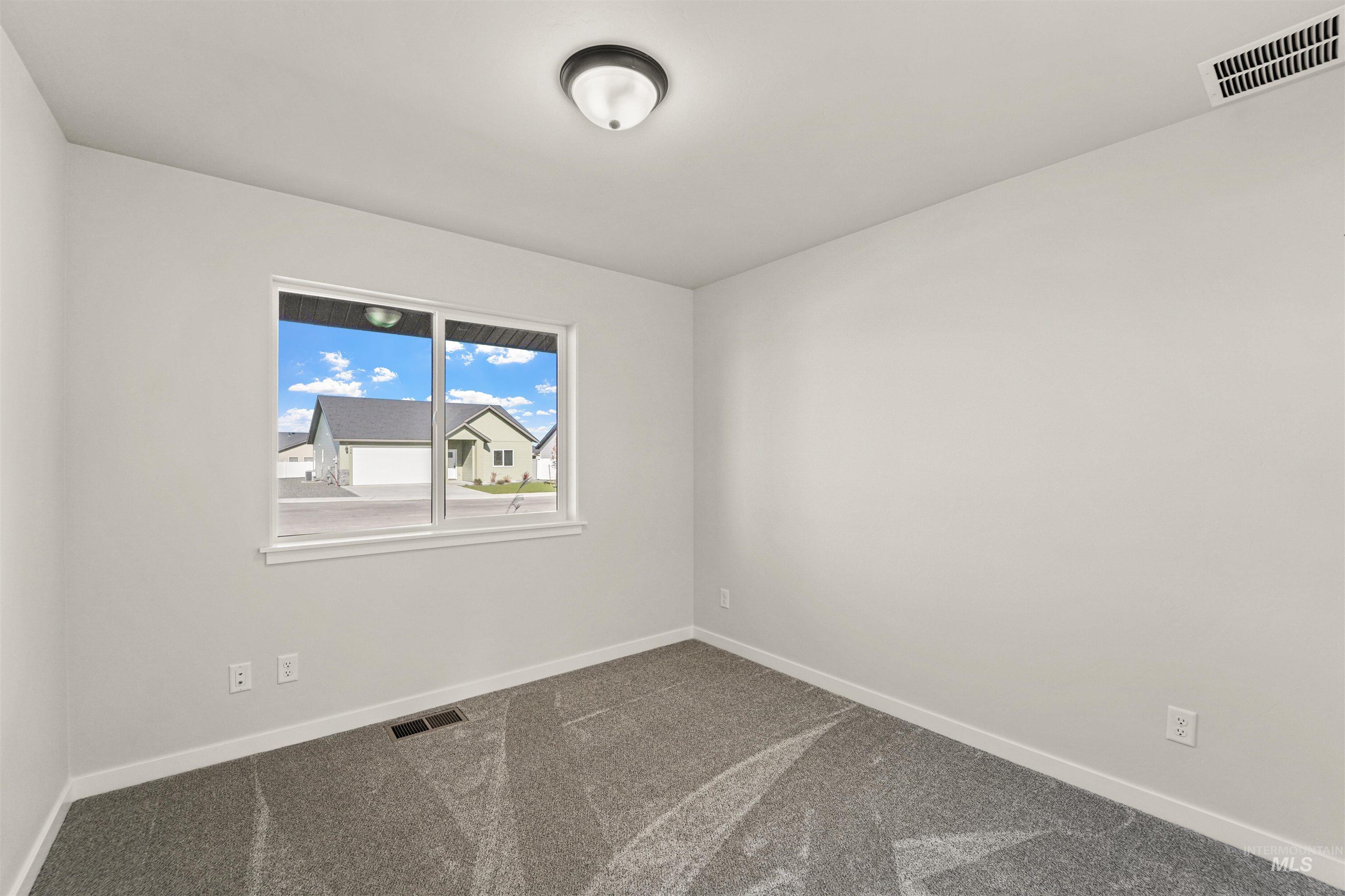Carpeted empty room with baseboards