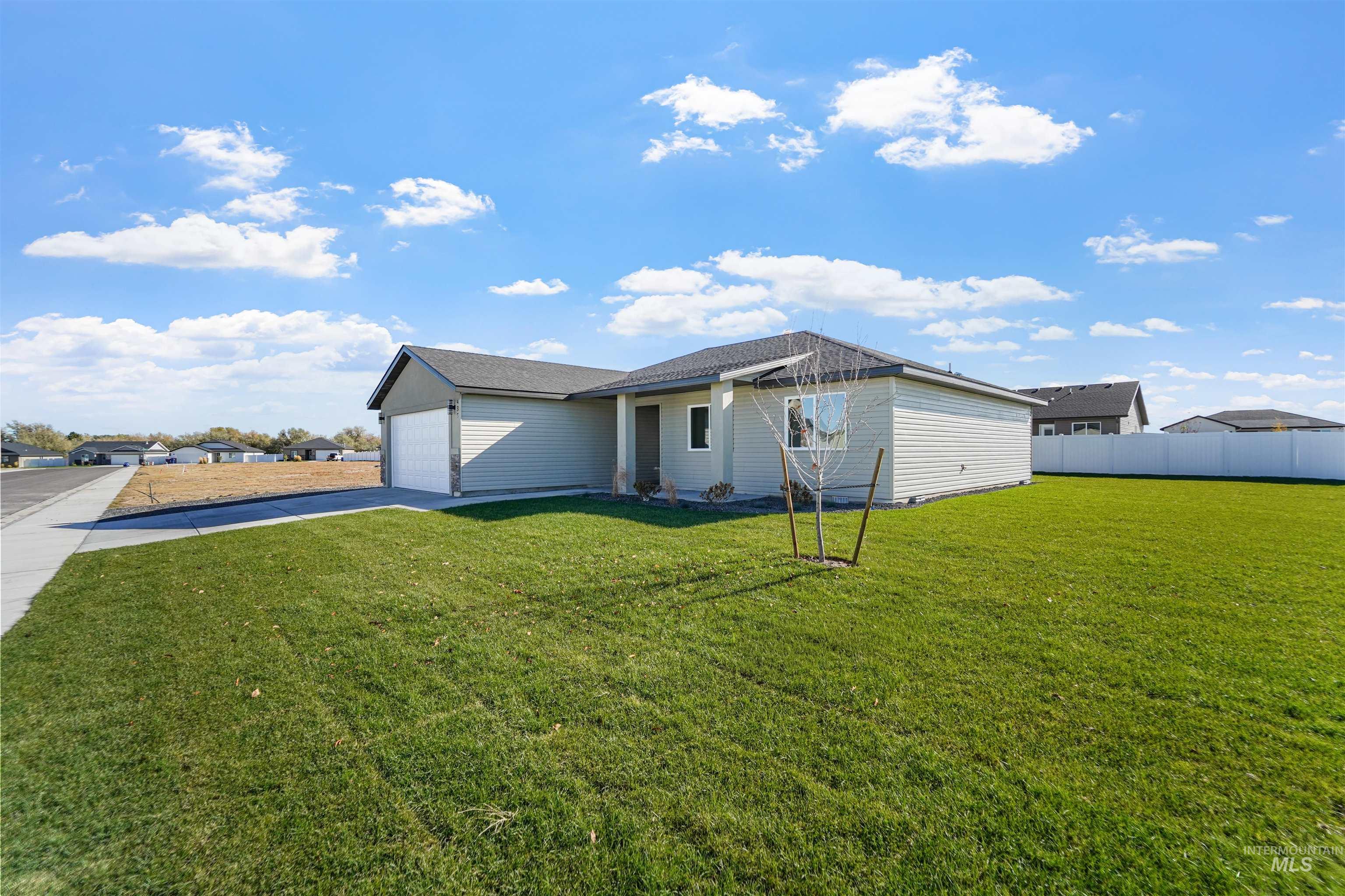 View of property exterior featuring concrete driveway and an attached garage