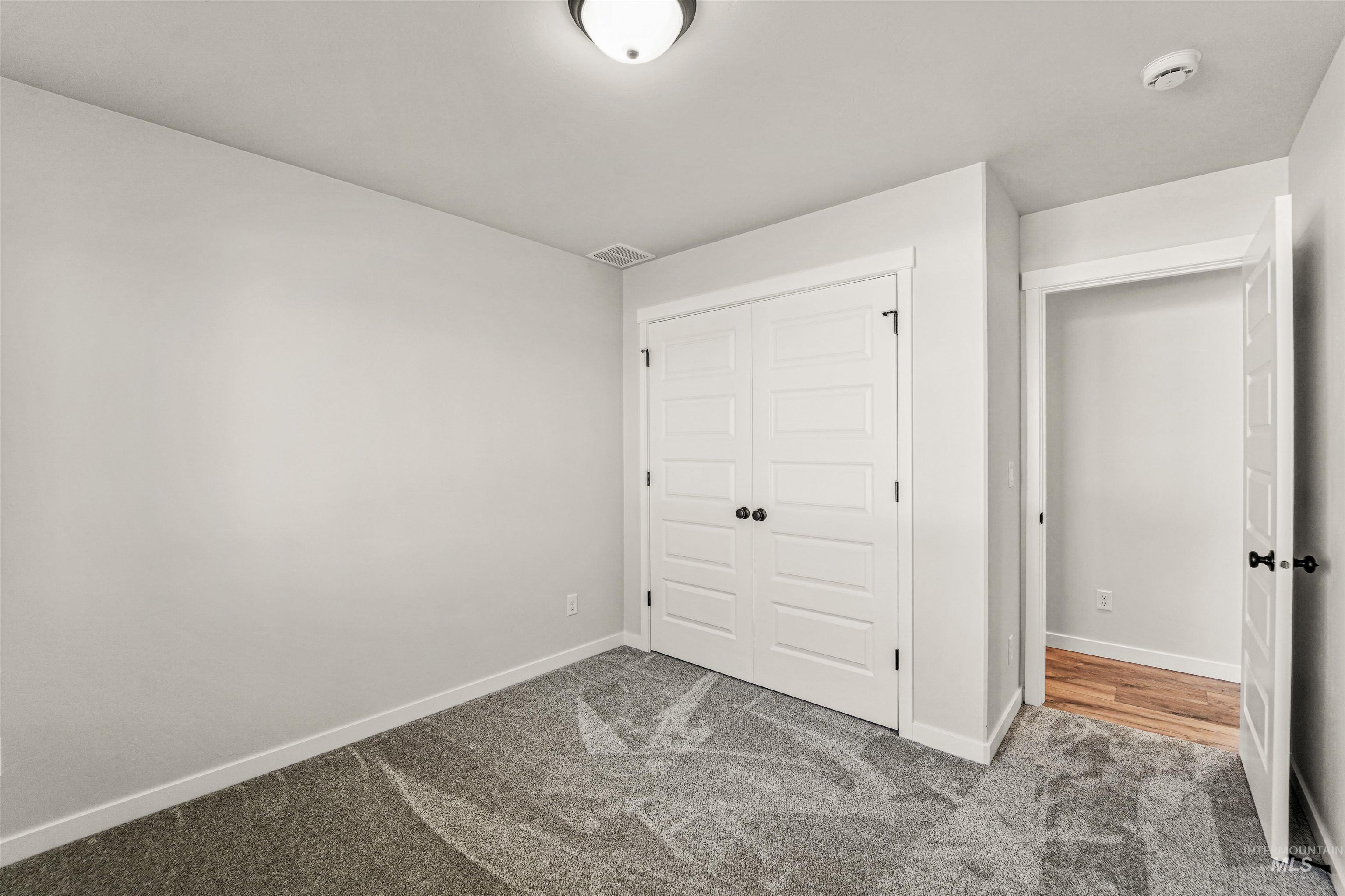 Unfurnished bedroom with carpet flooring and a closet
