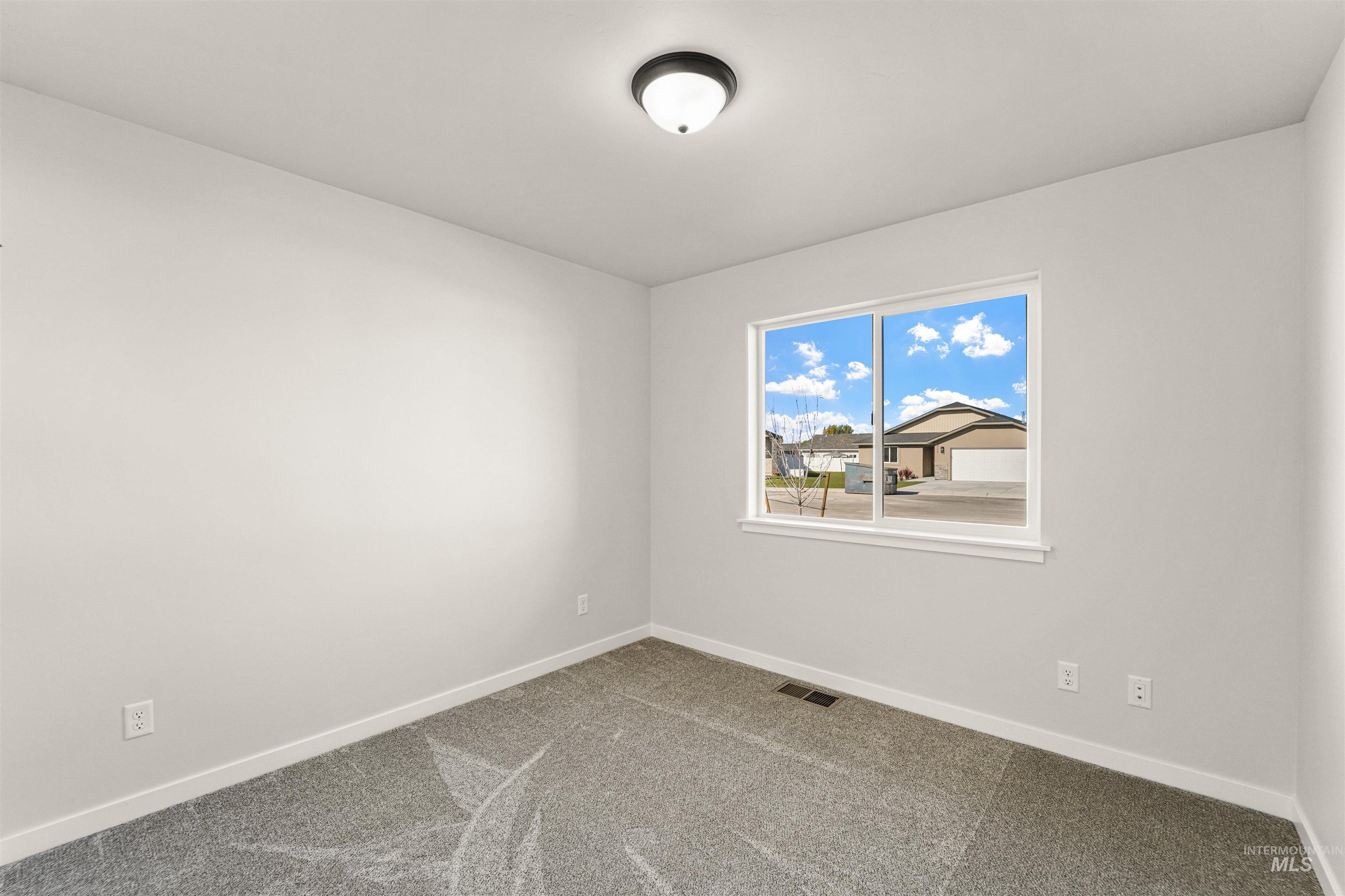 Spare room with carpet floors and baseboards
