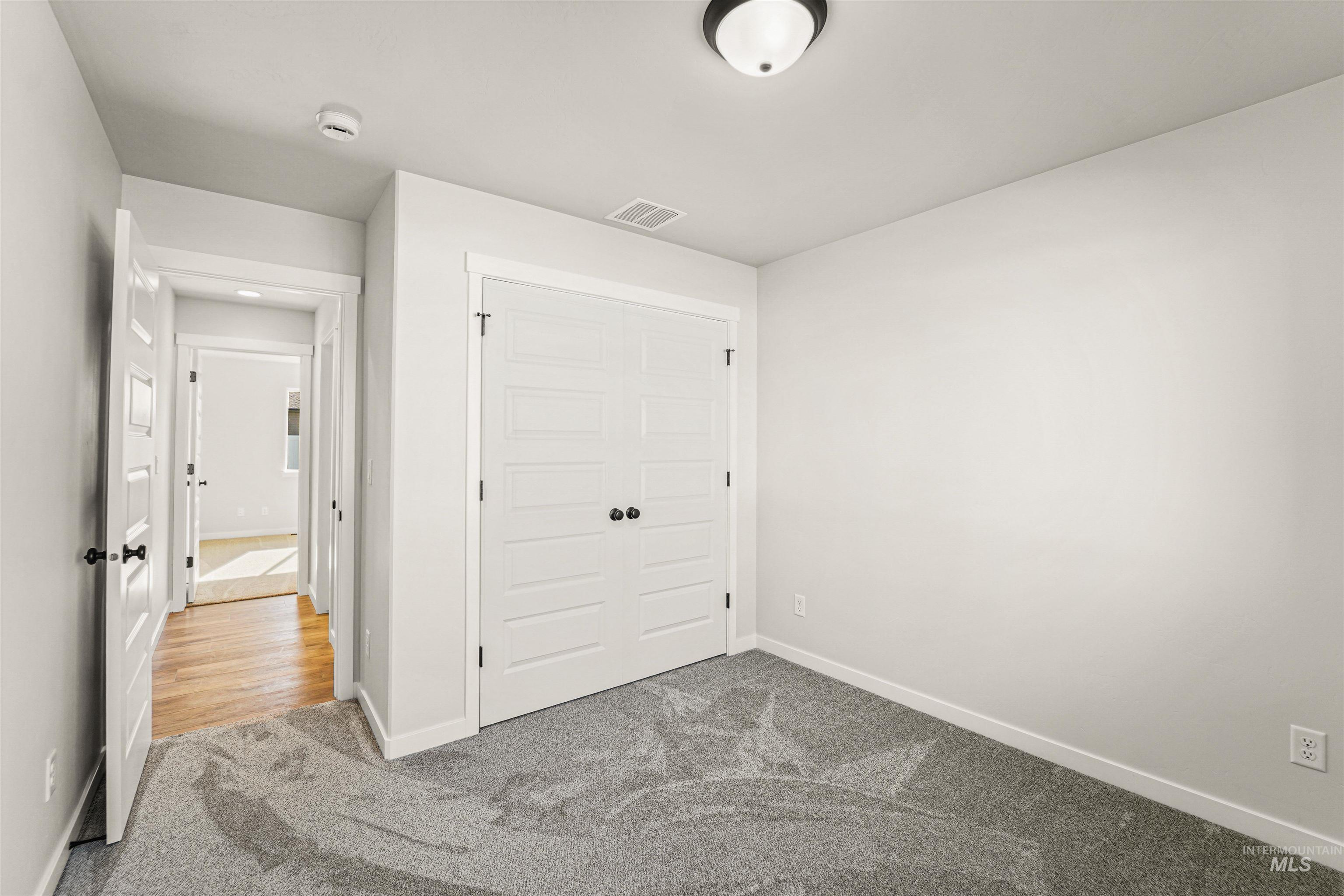 Unfurnished bedroom featuring carpet floors and a closet