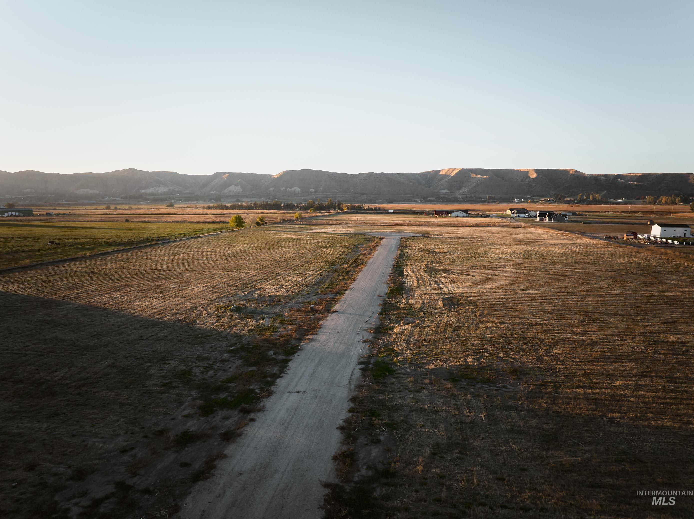 View of road featuring a view of countryside, agricultural area, and a mountain view