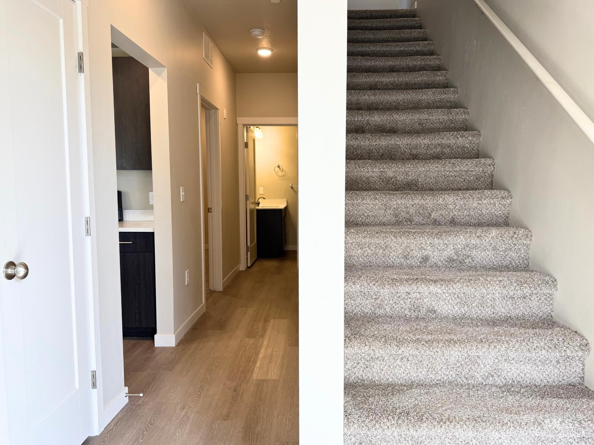 Staircase featuring wood finished floors and baseboards