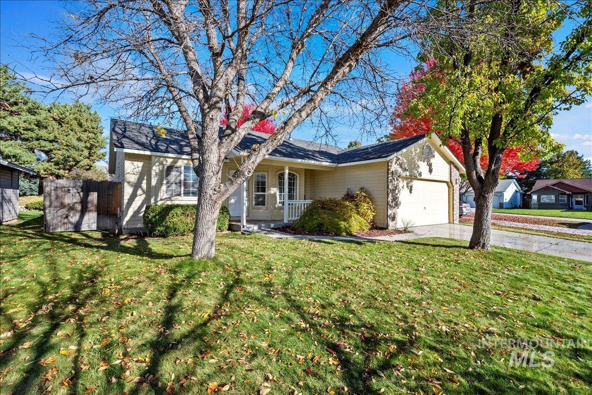 Ranch-style house featuring concrete driveway, a garage, and covered porch