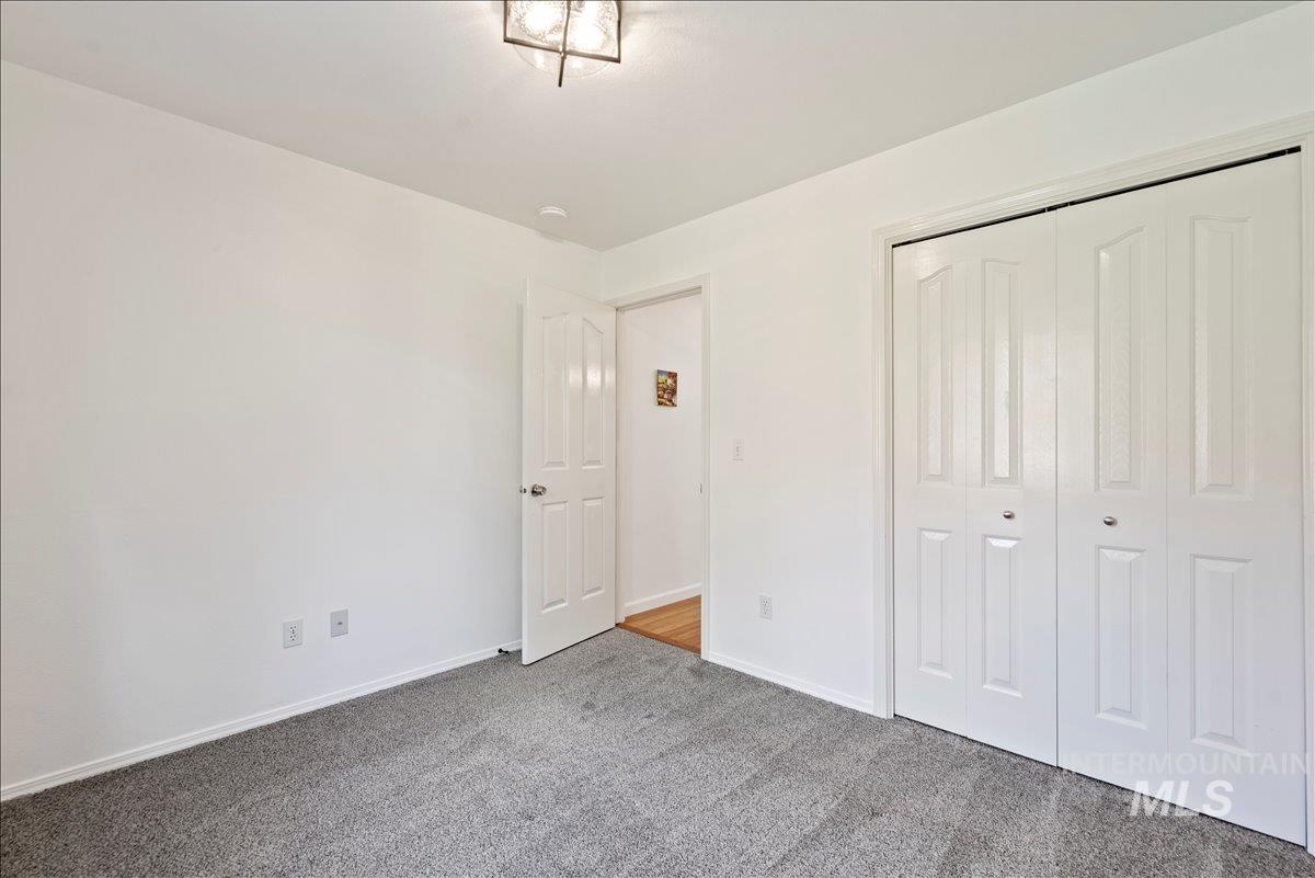 Unfurnished bedroom featuring carpet and a closet