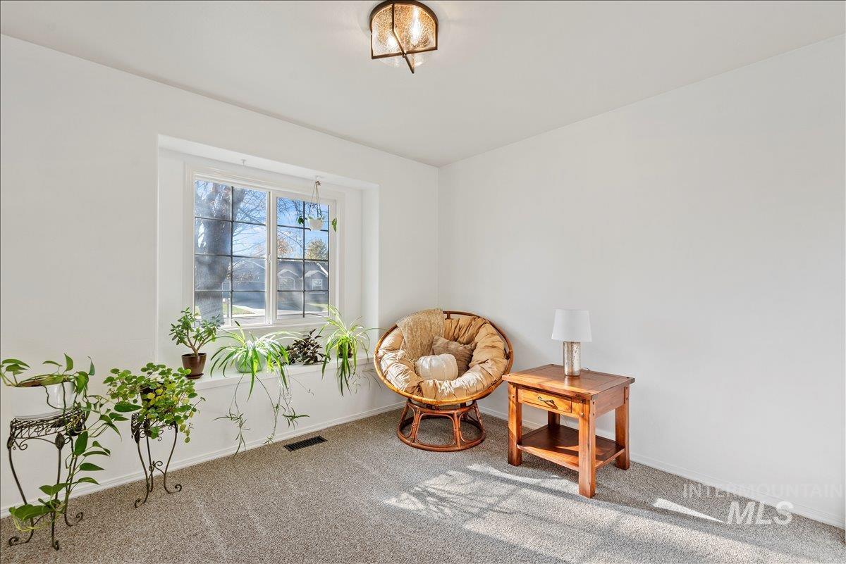 Living area with carpet floors and baseboards