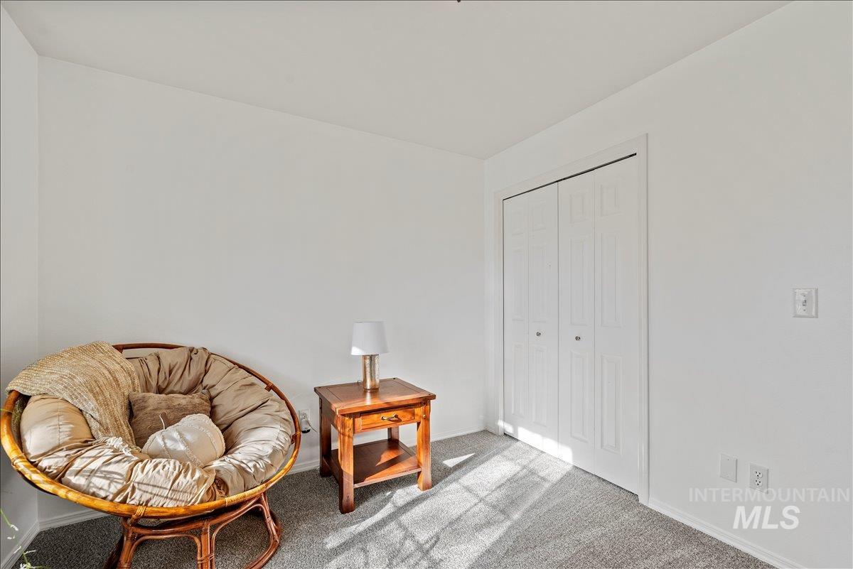 Sitting room with carpet and baseboards