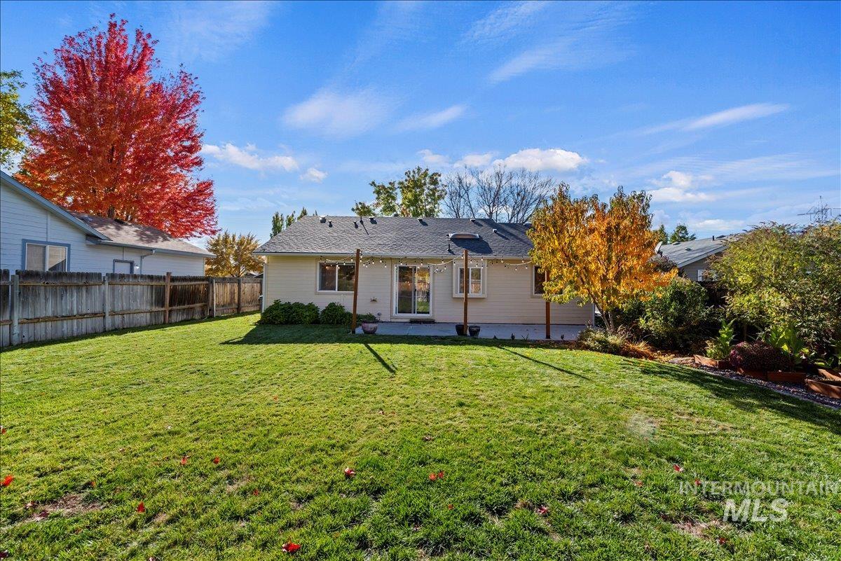 Rear view of house with a patio area and a fenced backyard