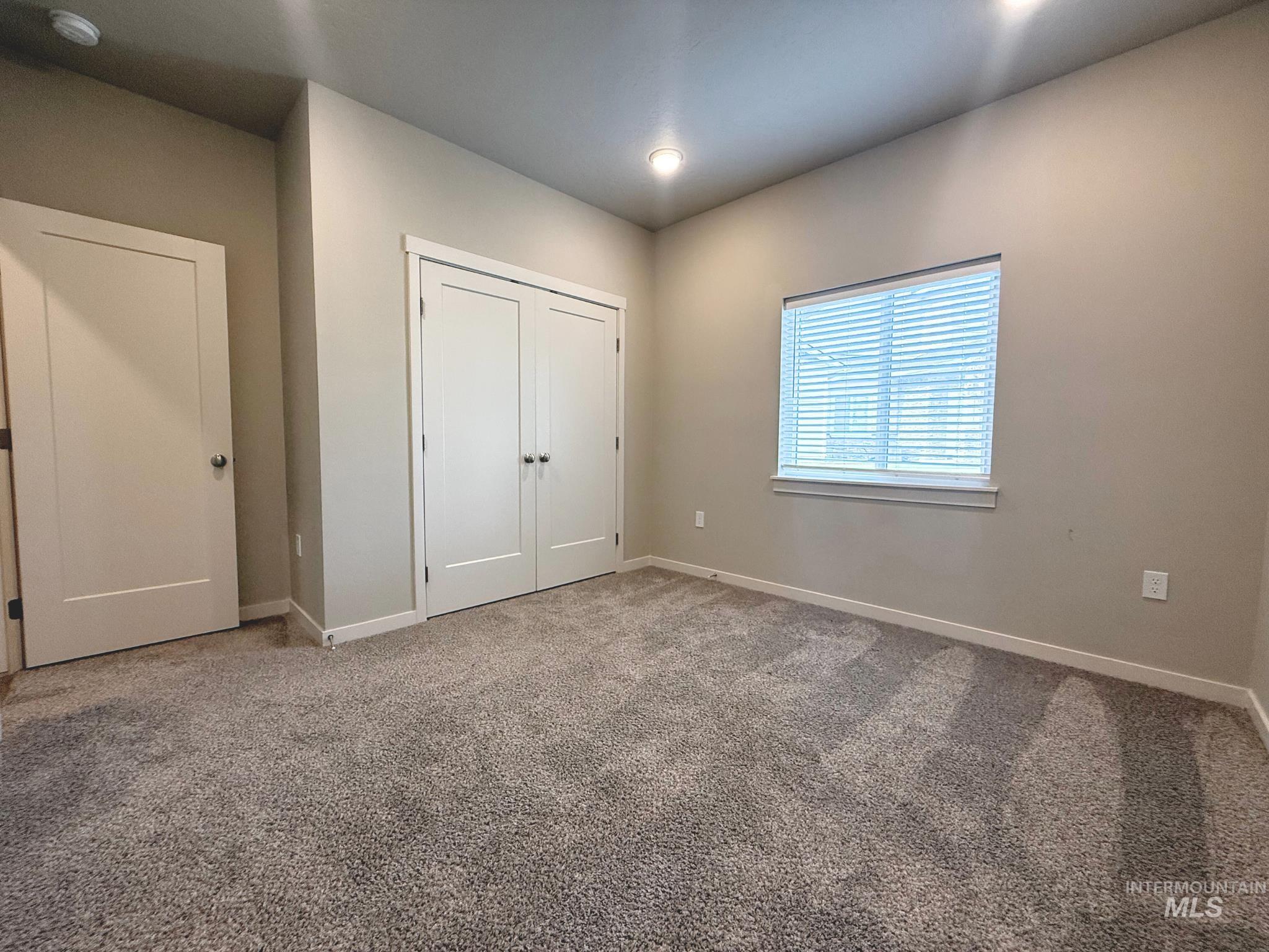 Unfurnished bedroom with carpet floors and a closet