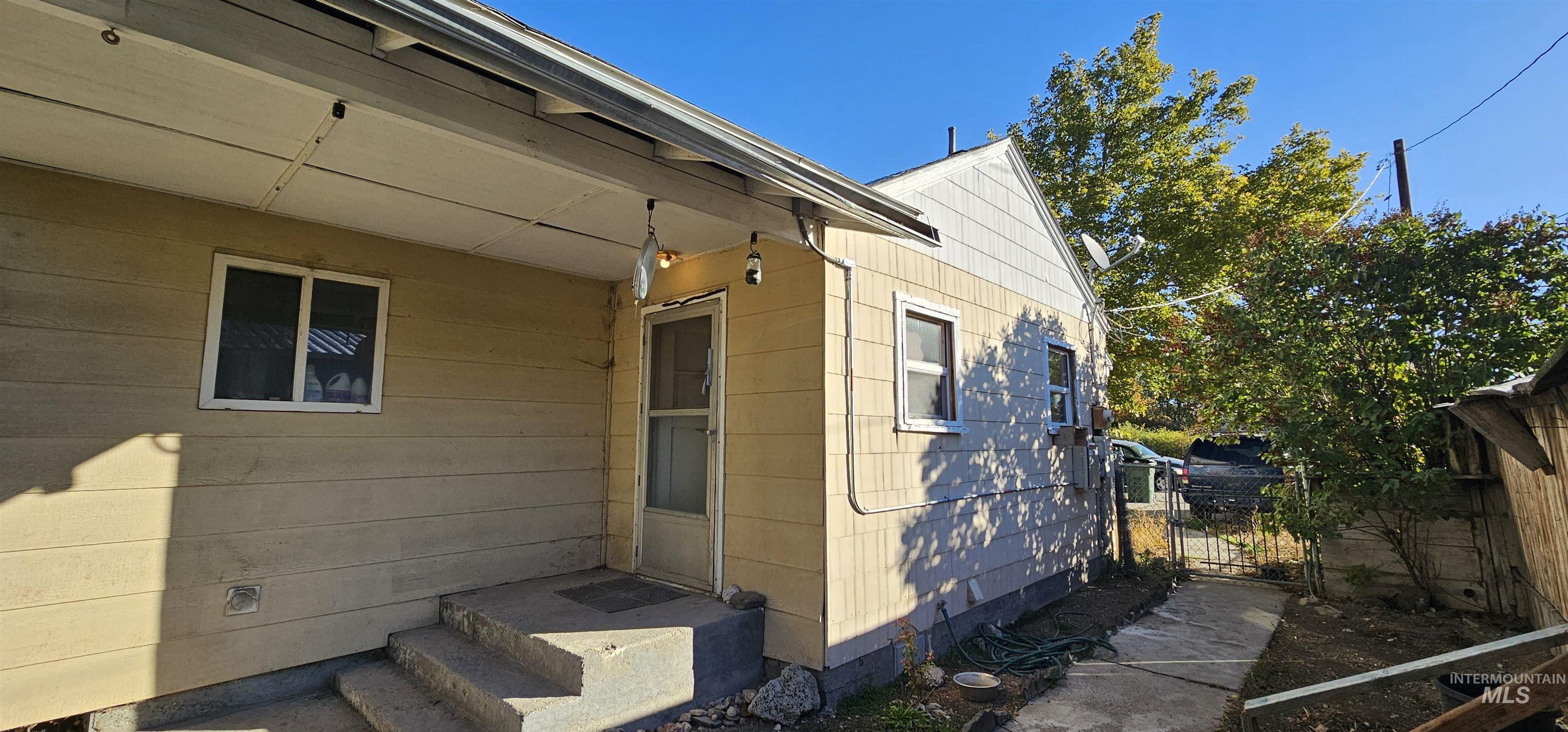 View of side of property with a gate
