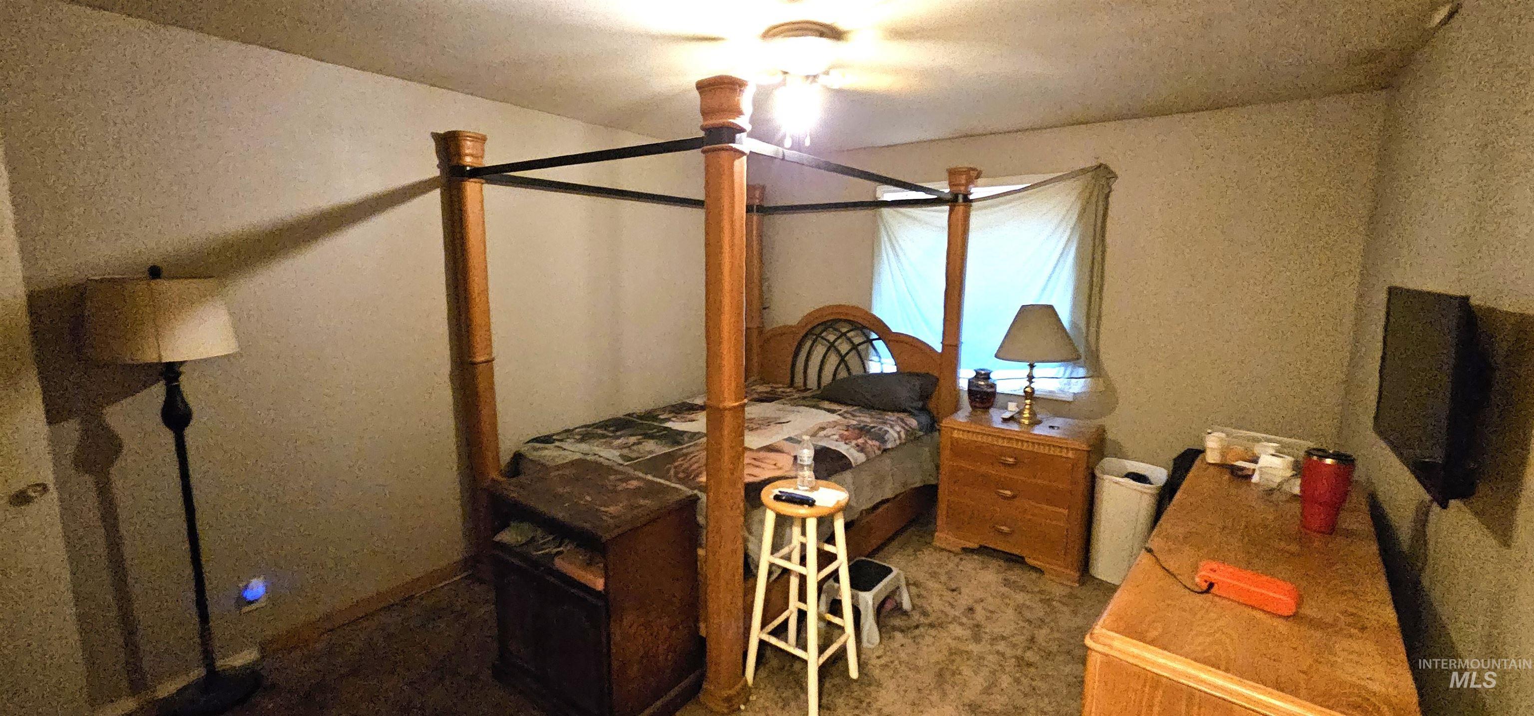 Carpeted bedroom with a textured ceiling