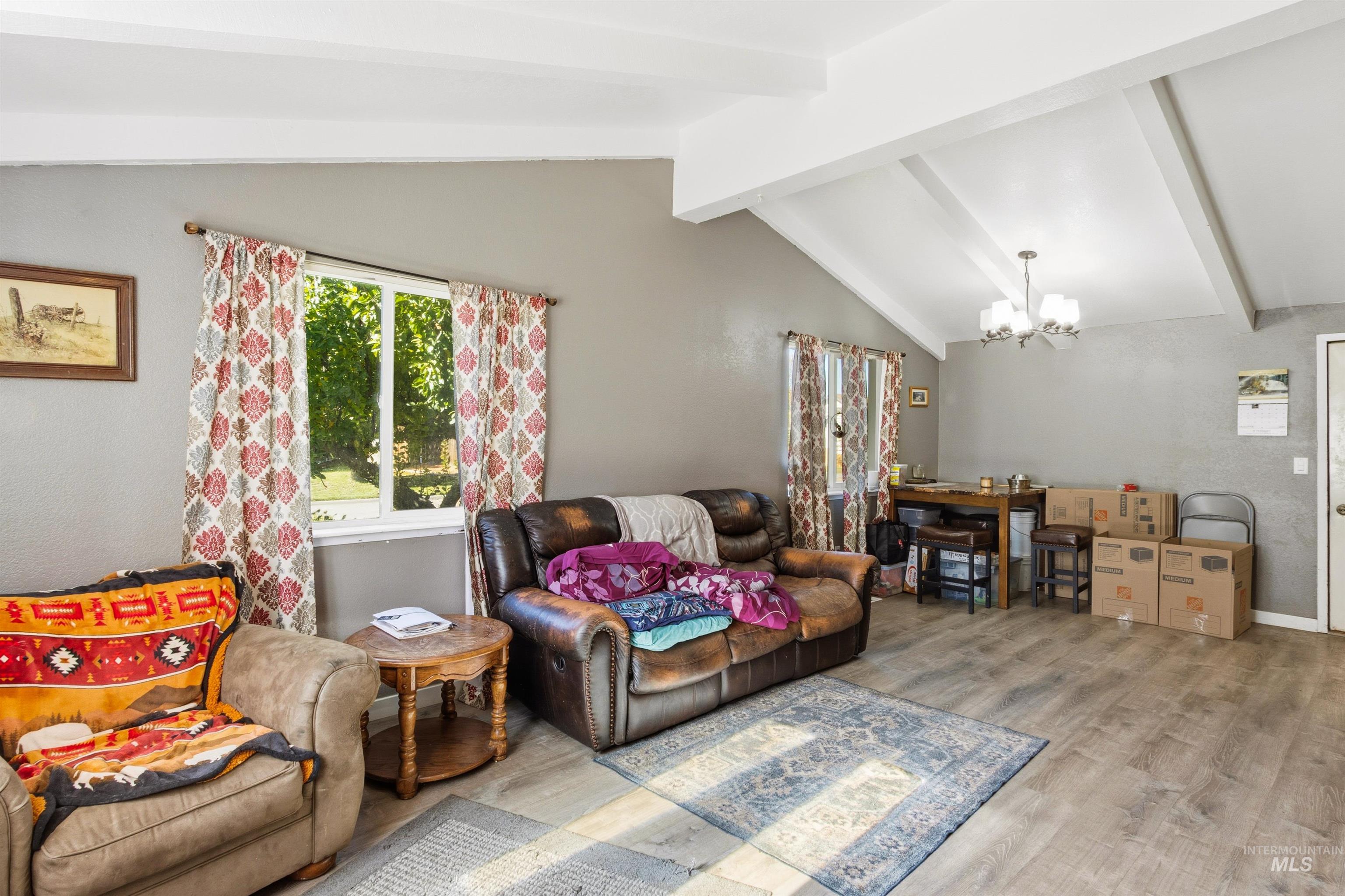 Living room with wood finished floors and a chandelier