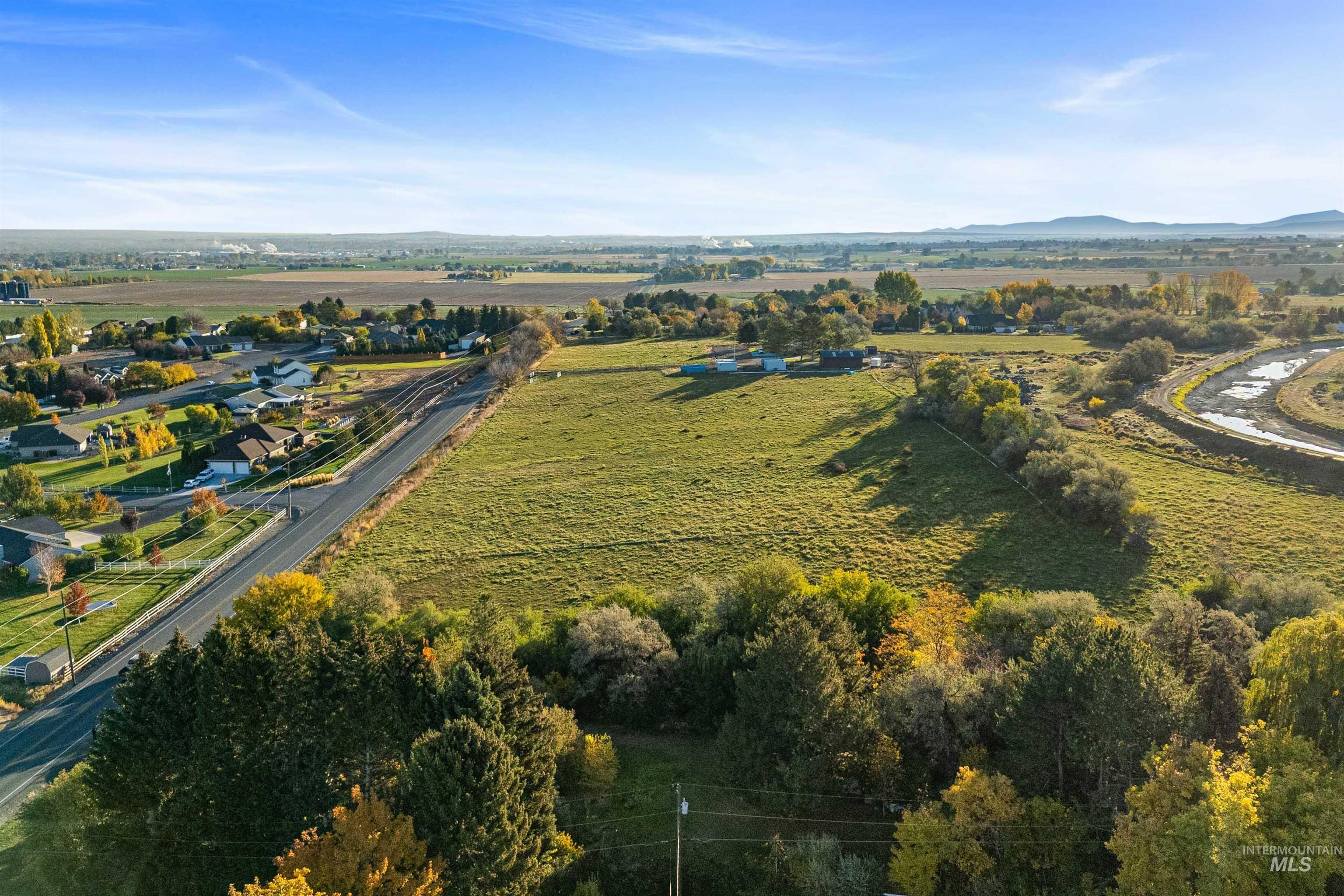 Aerial overview of property's location with rural landscape and a mountain backdrop