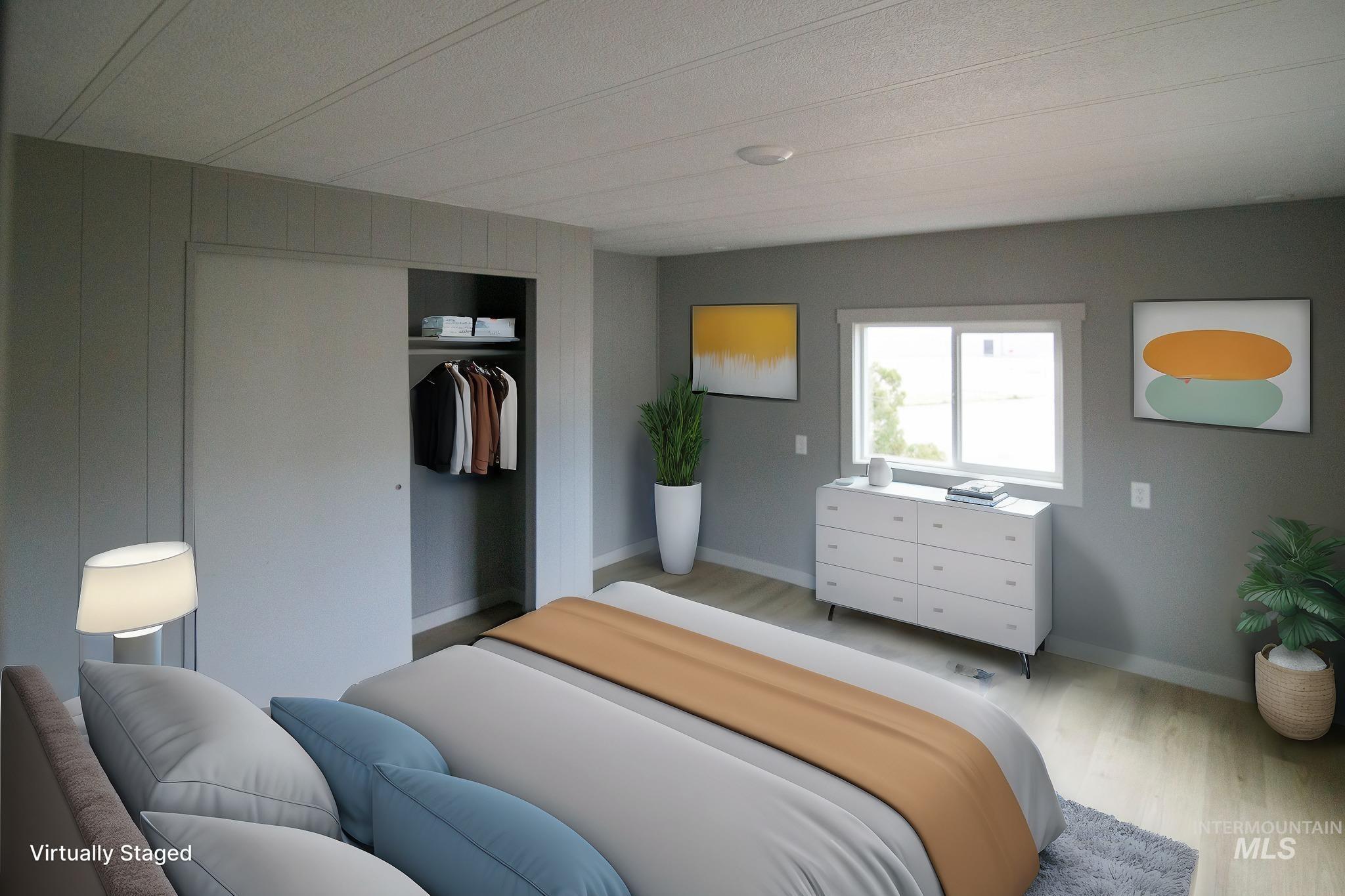 Bedroom featuring light wood finished floors and a closet