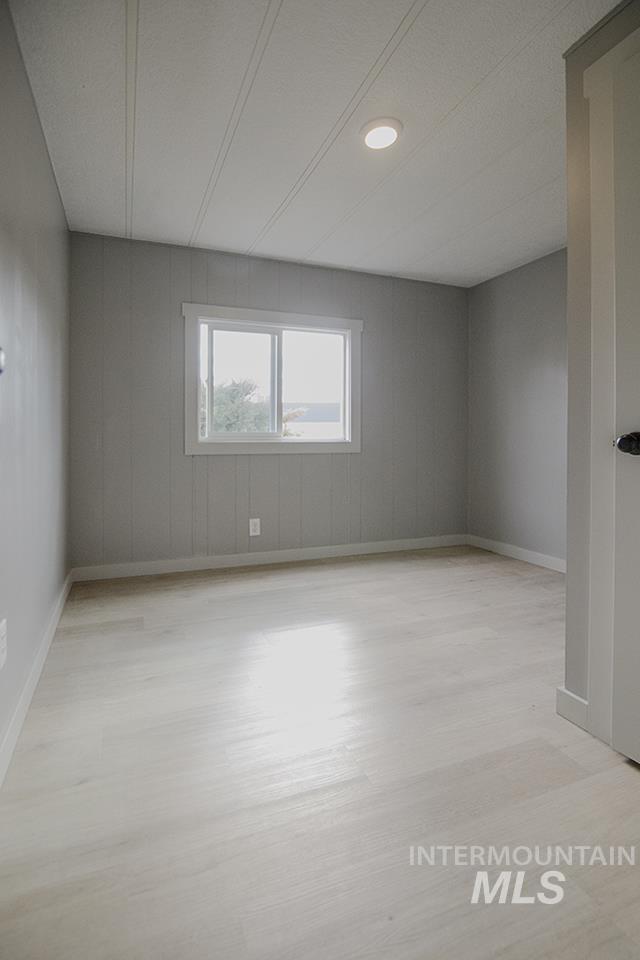 Spare room featuring light wood finished floors and recessed lighting
