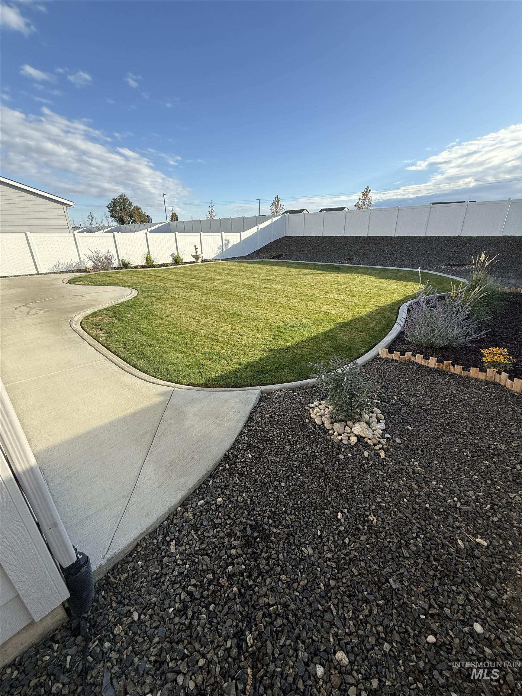 Fenced backyard with a patio