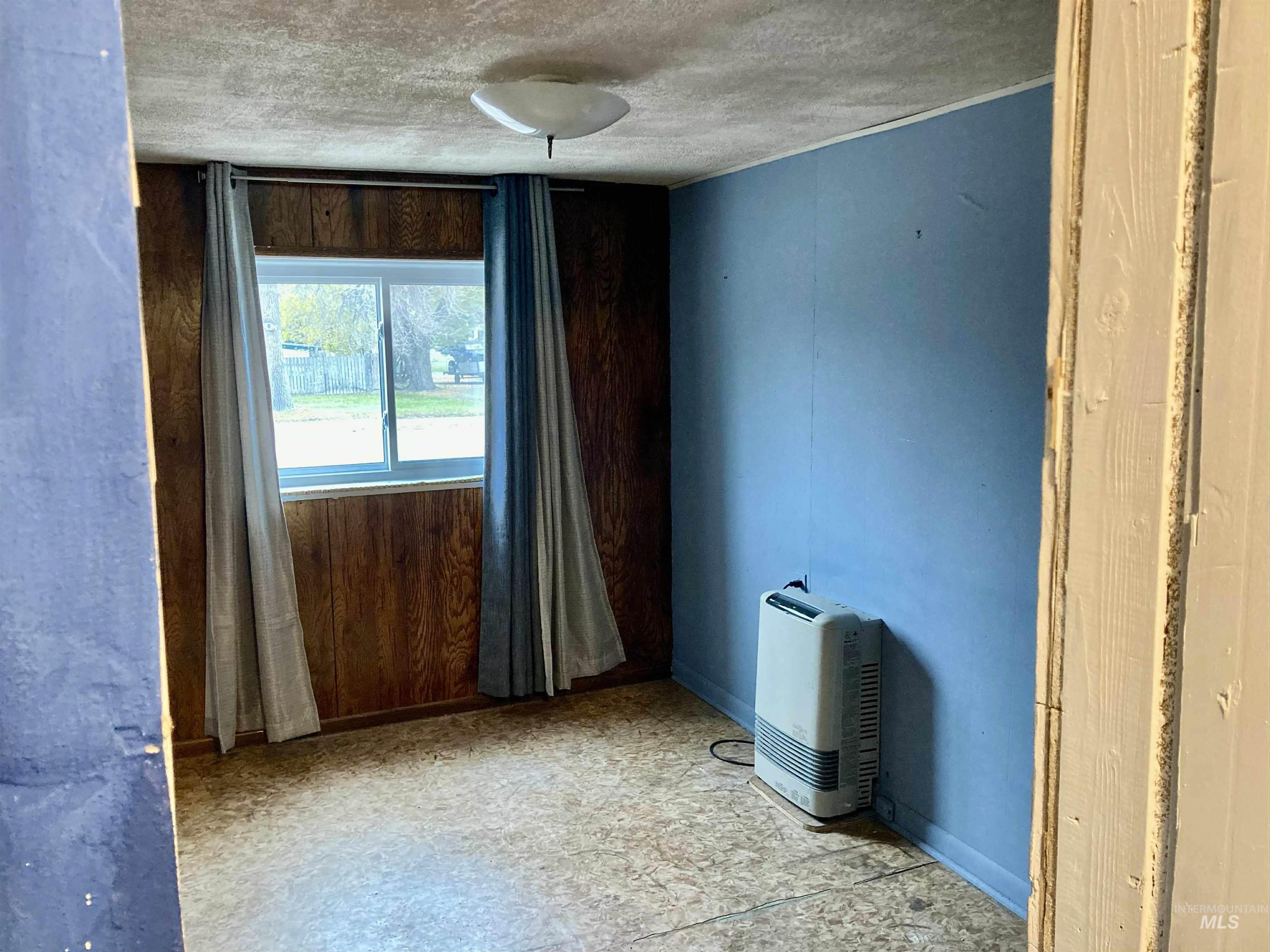 Spare room with a textured ceiling and light flooring