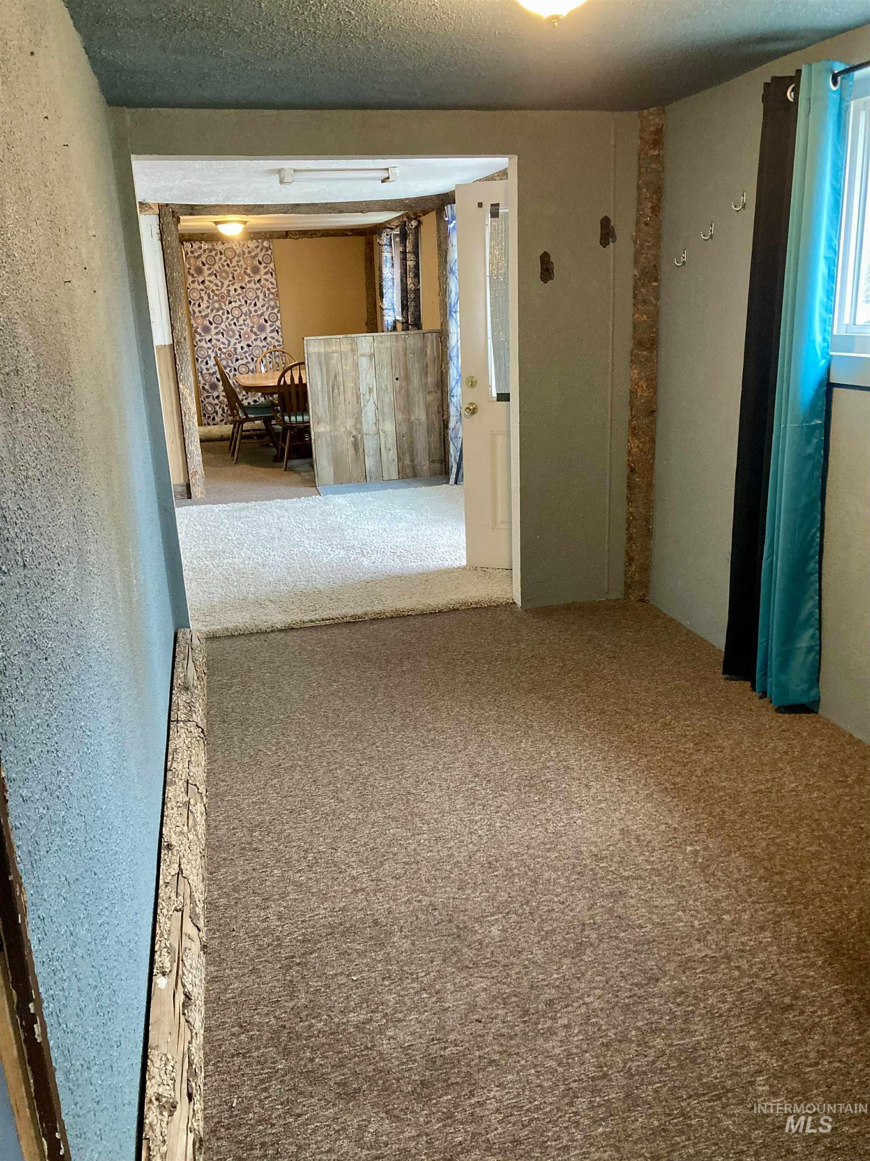 Carpeted empty room featuring a textured ceiling