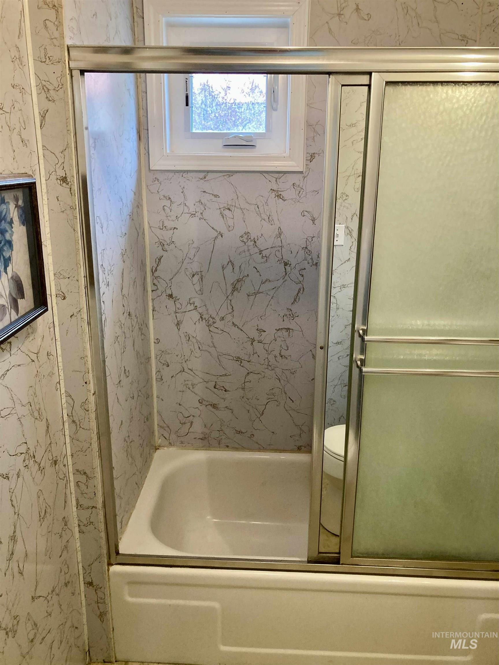 Bathroom with enclosed tub / shower combo