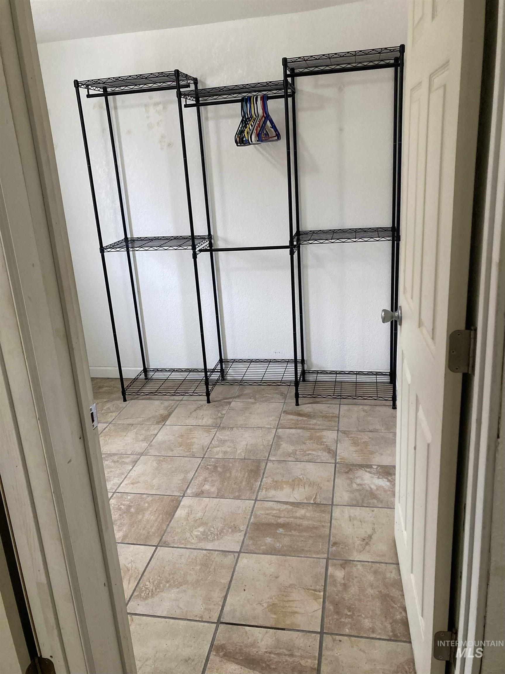 Unfurnished bedroom featuring light tile patterned floors