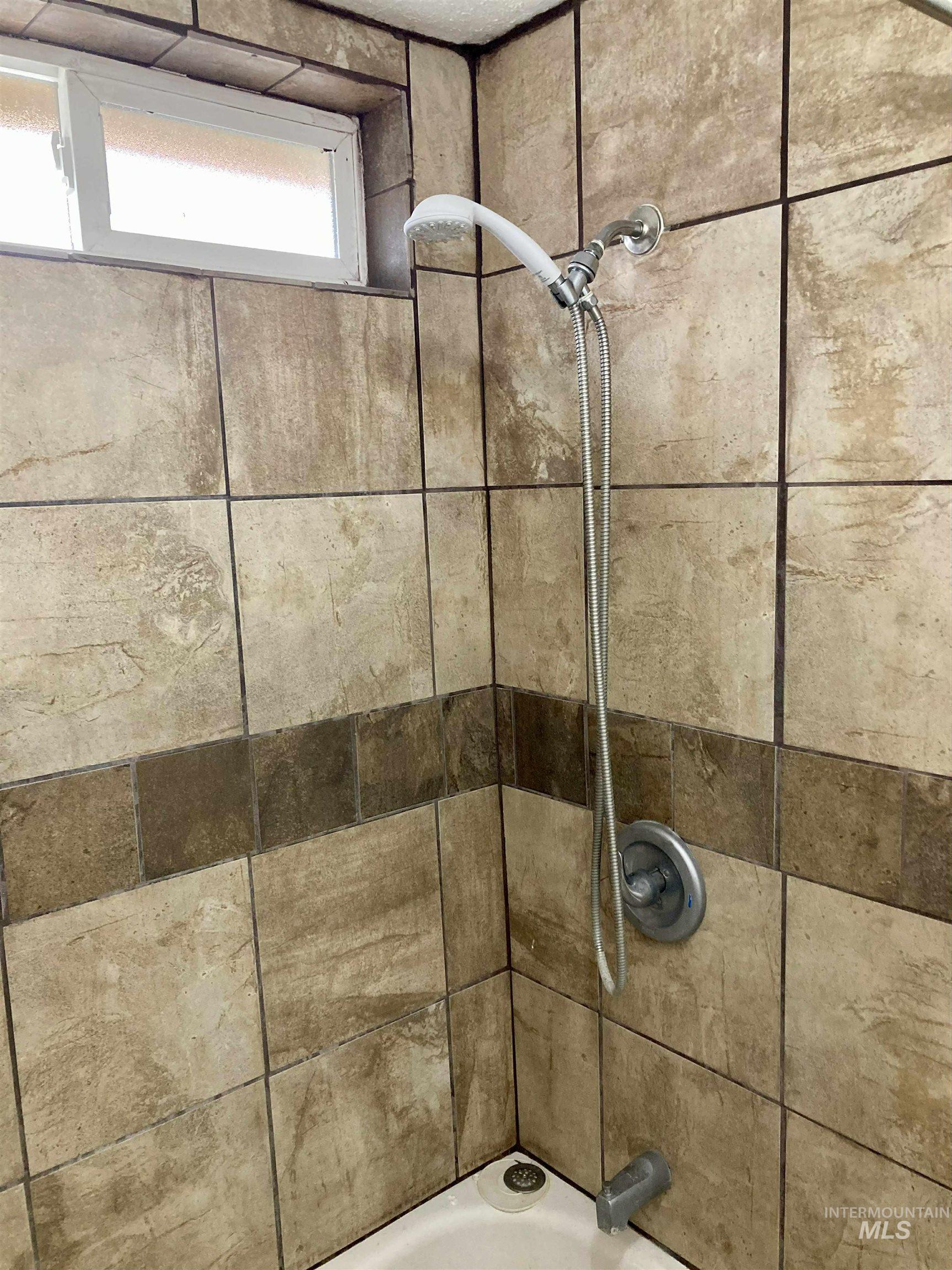 Bathroom view of shower / bathtub combination