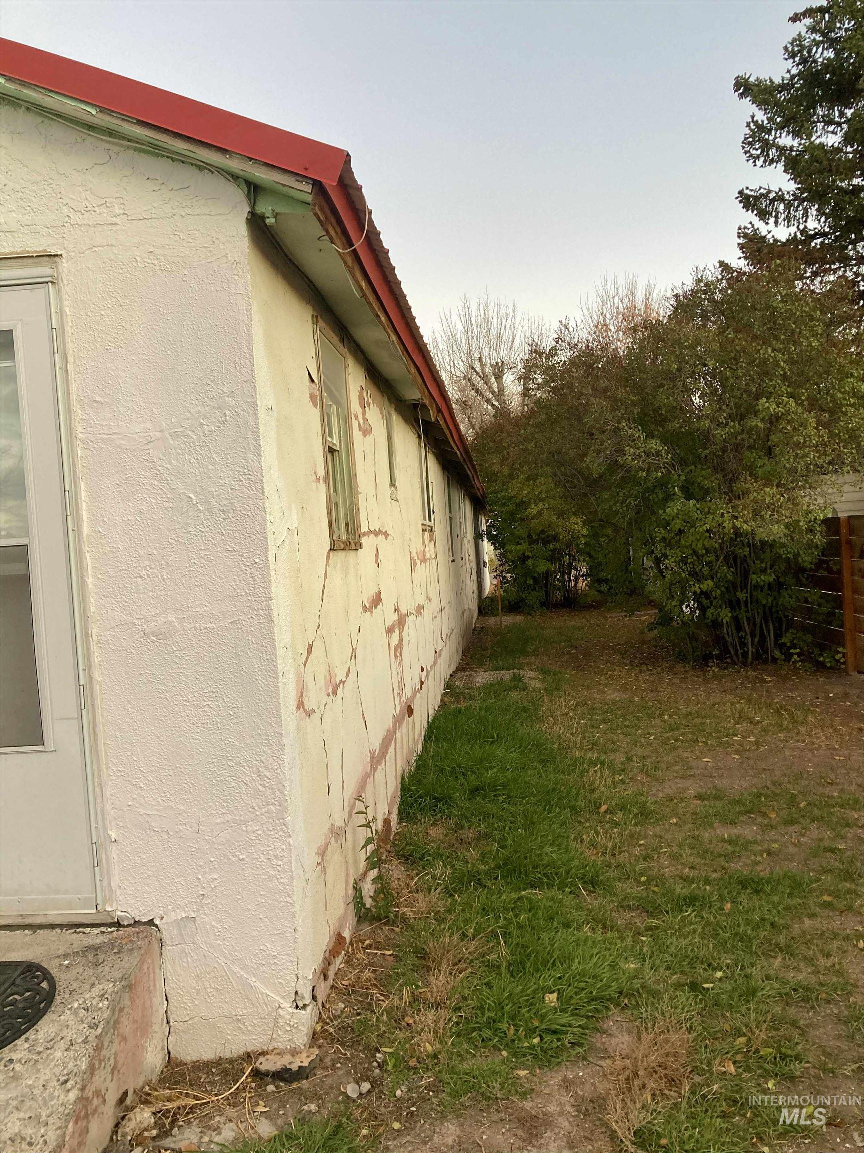 View of home's exterior with a lawn and stucco siding