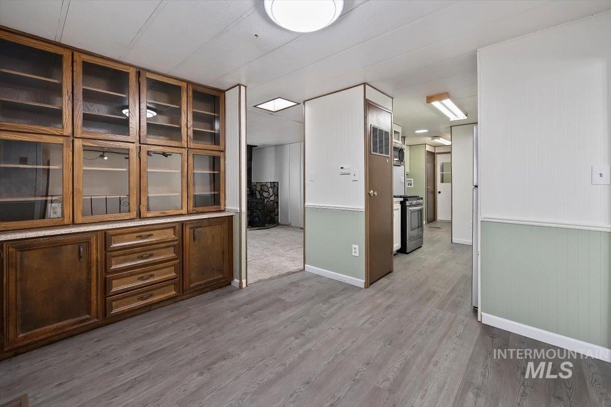 Unfurnished room with dark wood-type flooring and baseboards