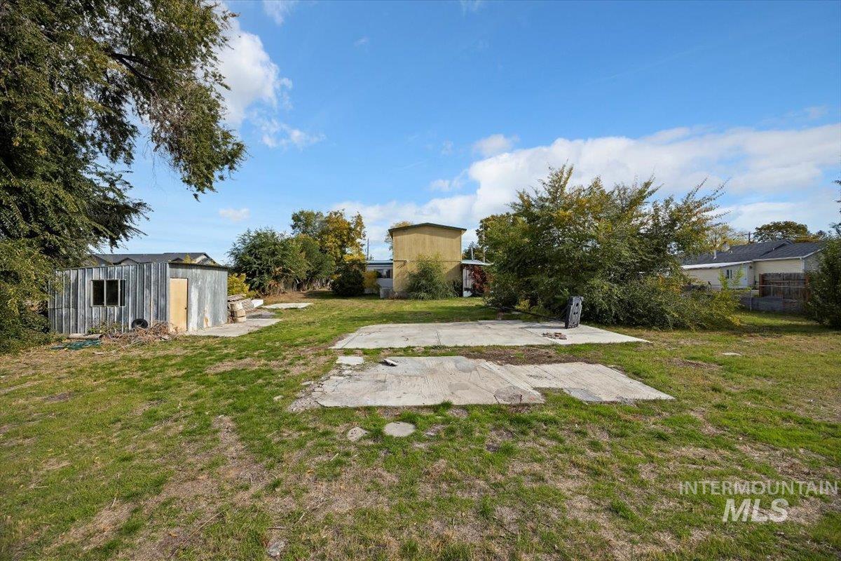 View of yard featuring a patio and an outdoor structure