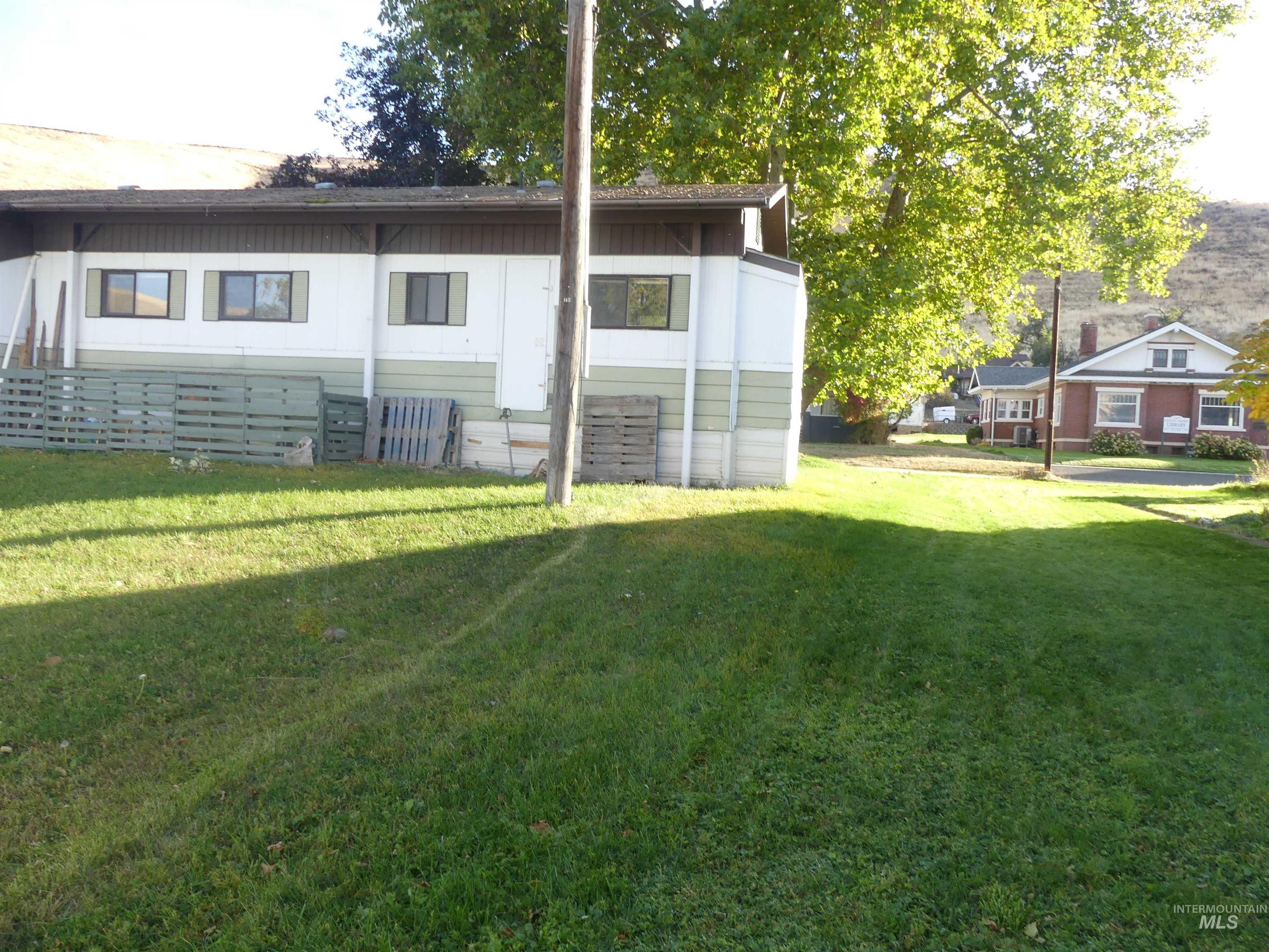 Rear view of property with a lawn
