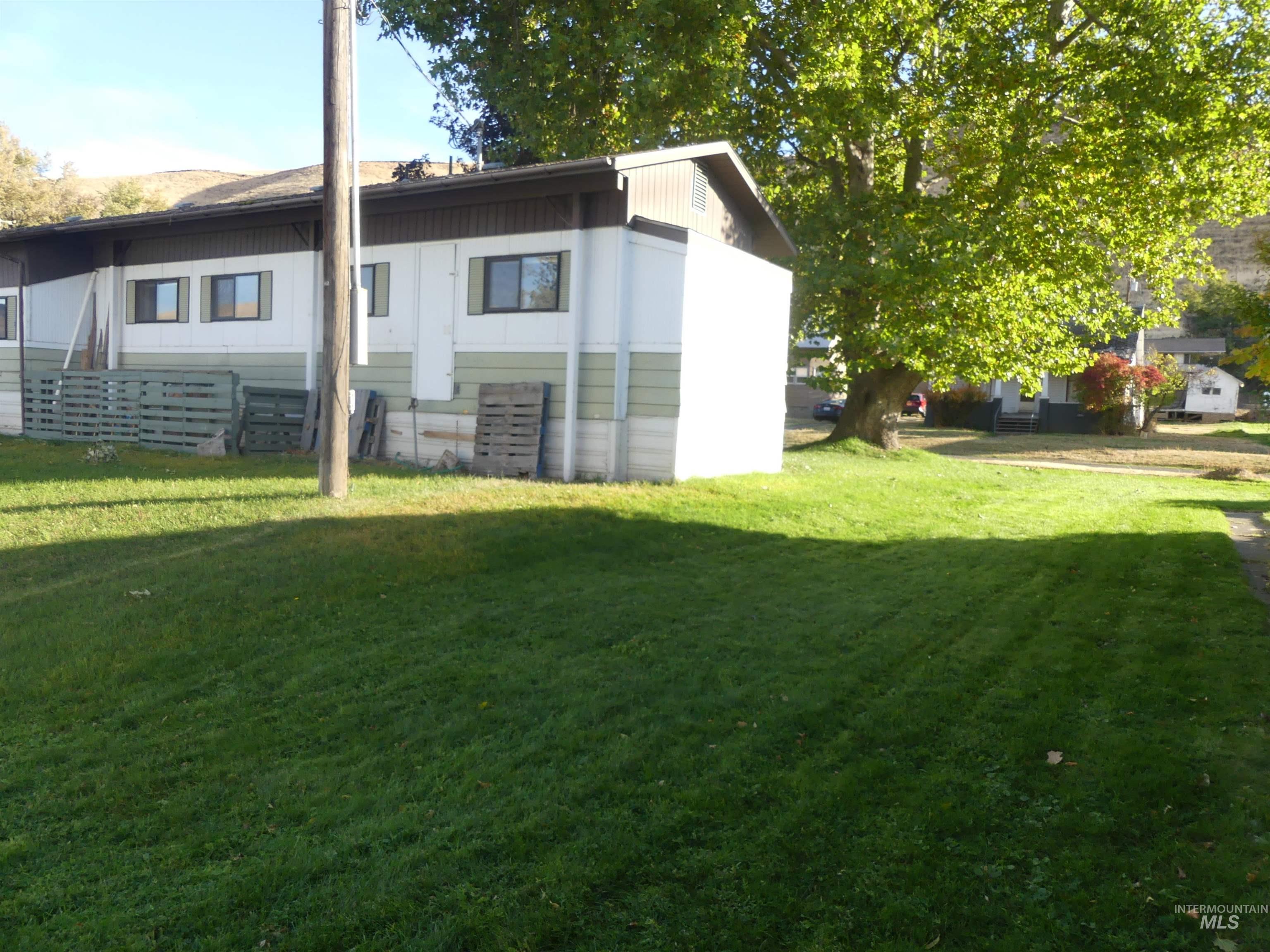 Rear view of house featuring a lawn