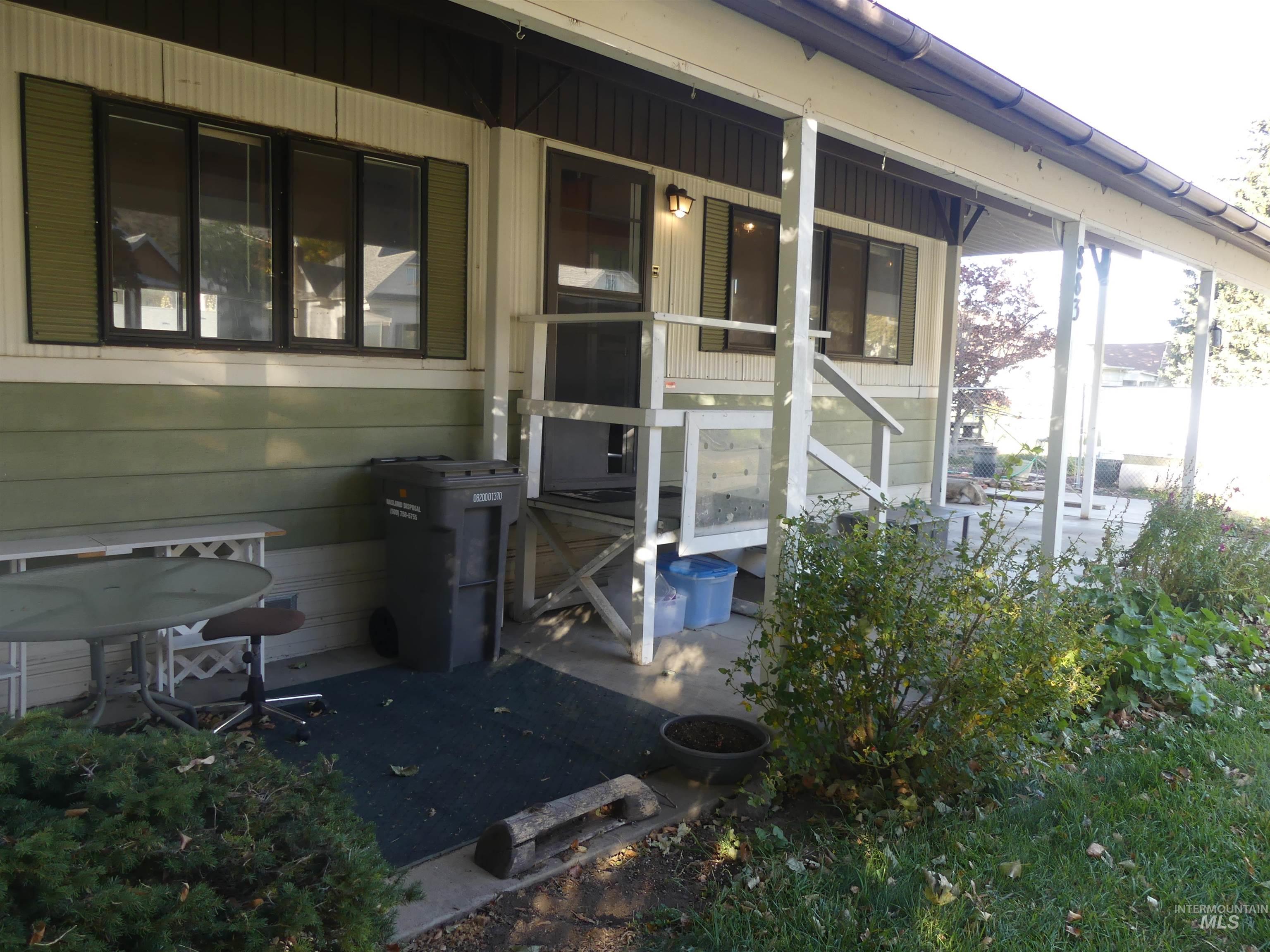 Doorway to property featuring a sunroom and a porch