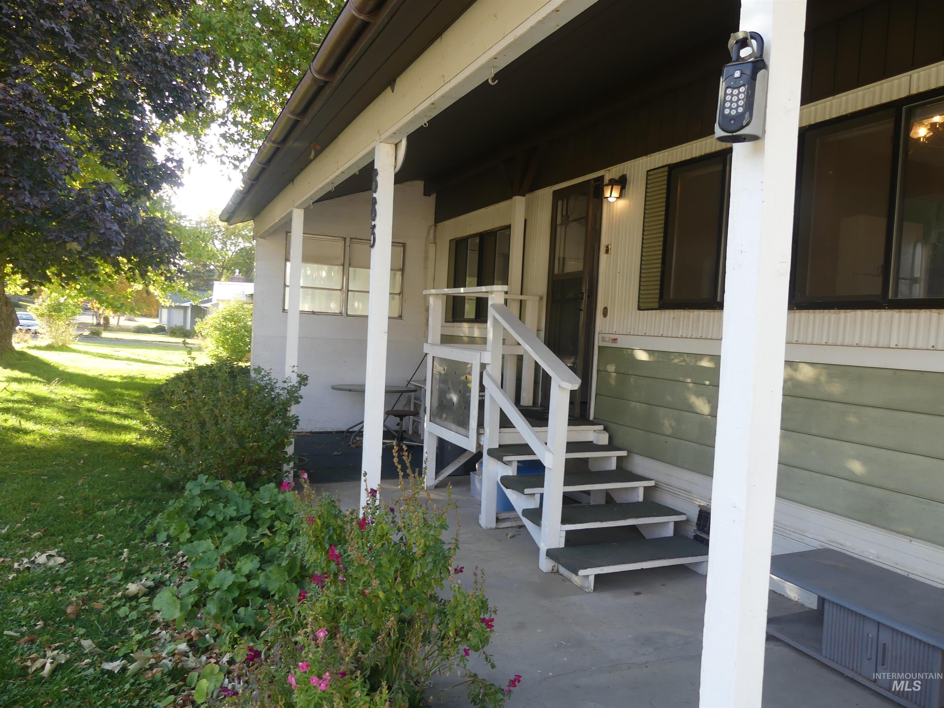 Entrance to property with a lawn