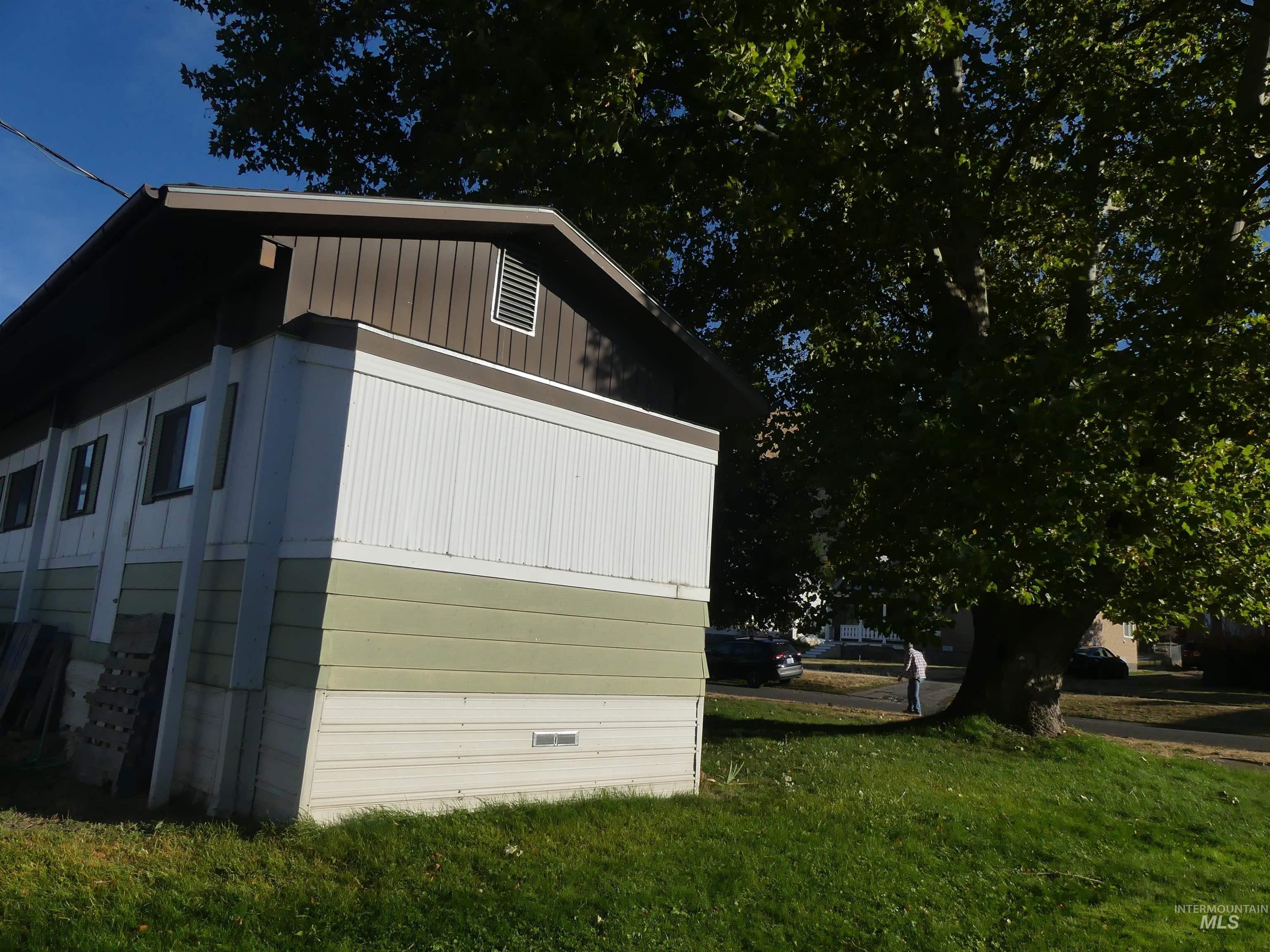 View of property exterior with a lawn