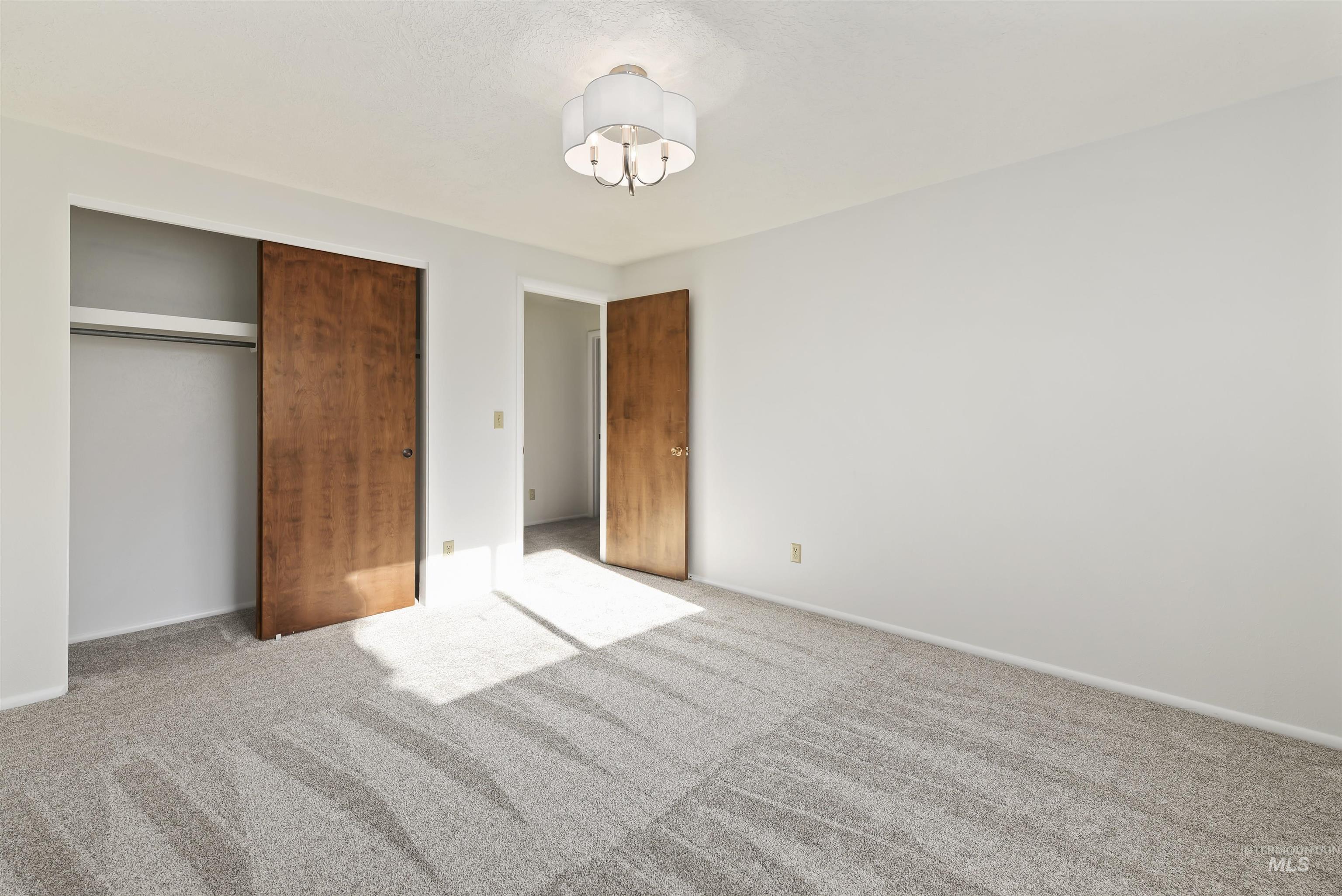 Unfurnished bedroom with carpet flooring and a closet
