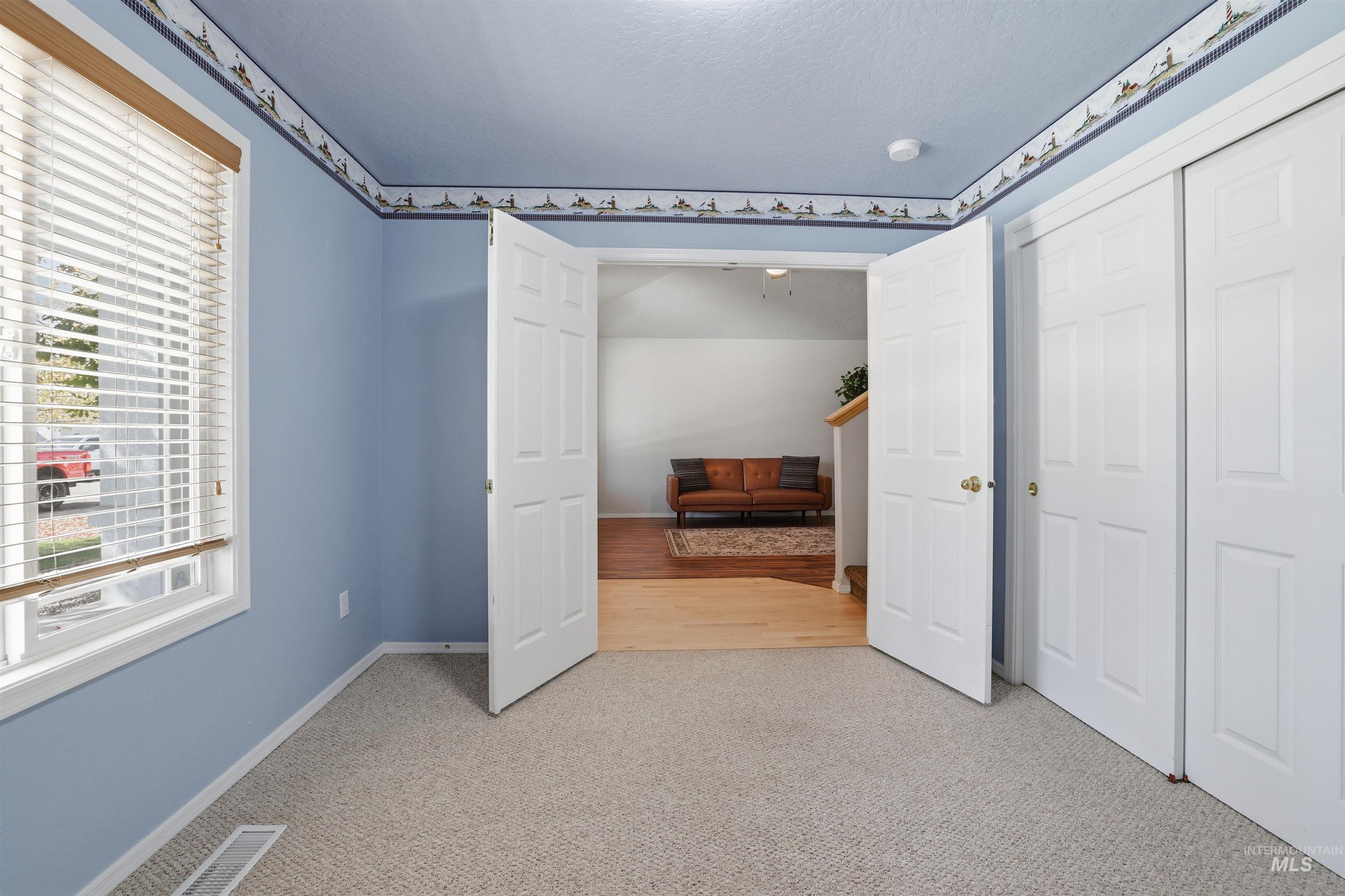 Unfurnished bedroom with light carpet and a closet
