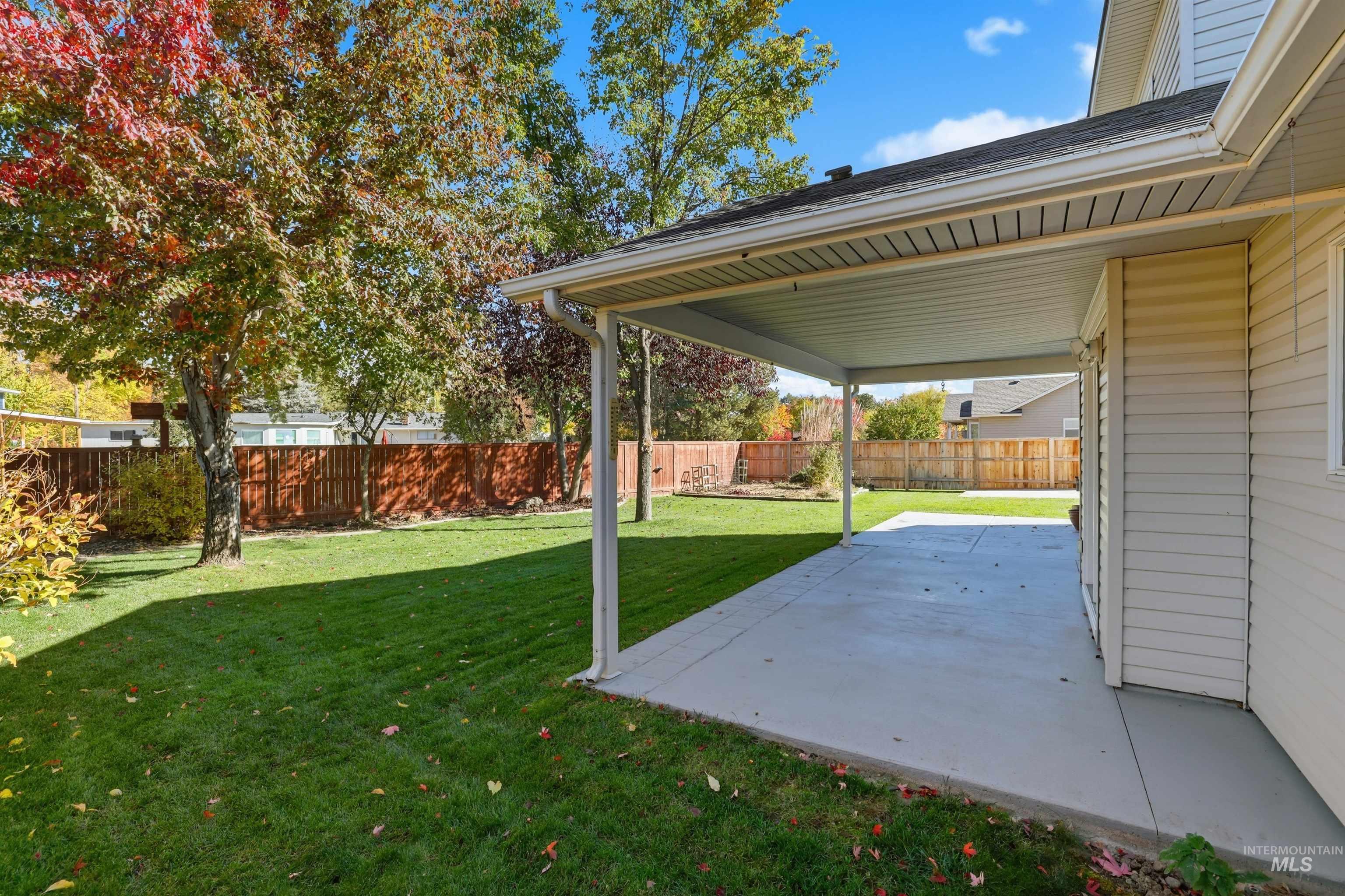 Fenced backyard with a patio area