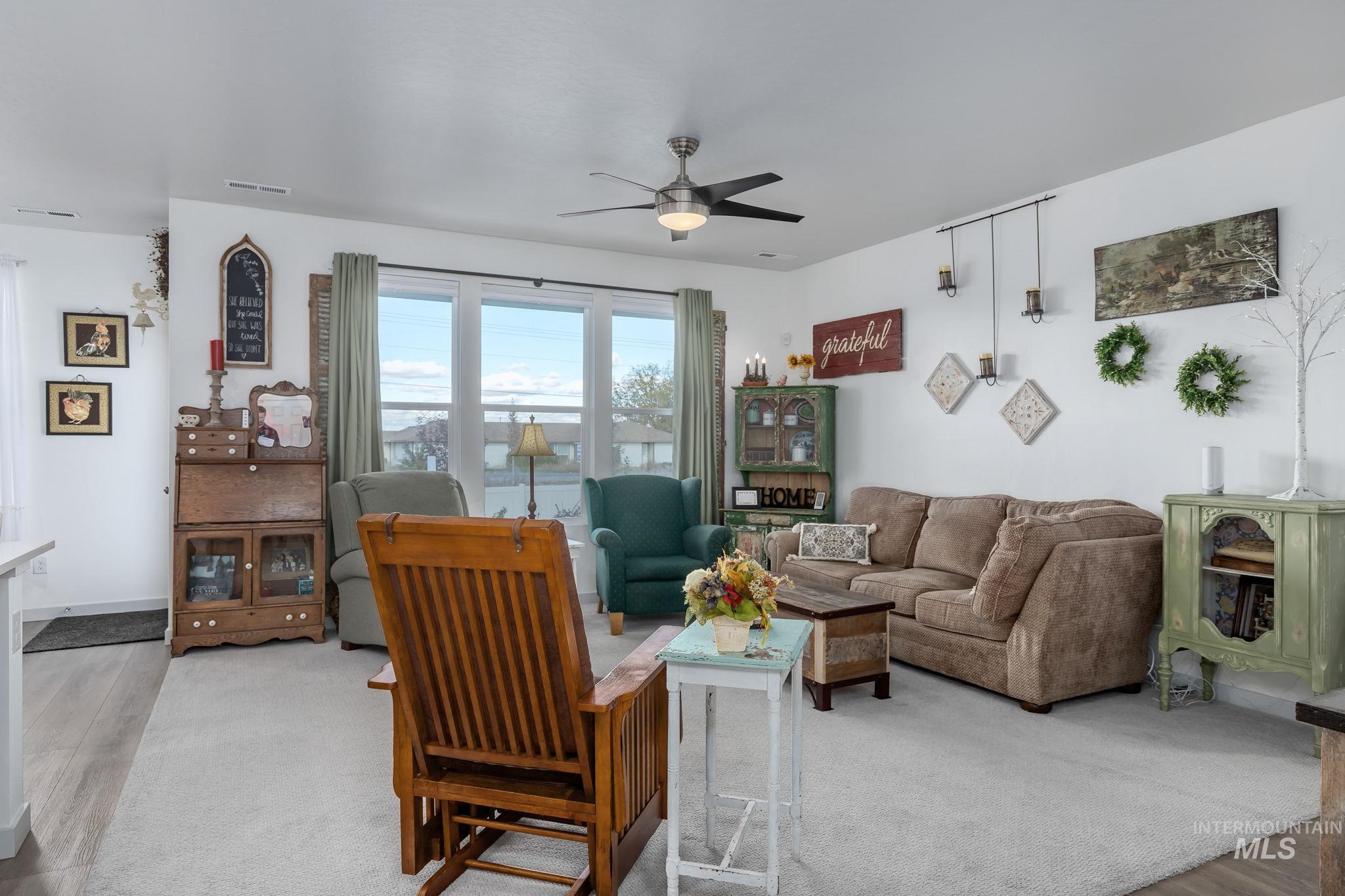 Living area featuring wood finished floors and ceiling fan