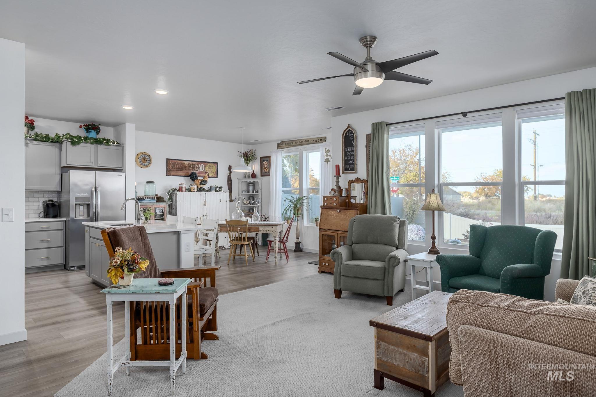 Living area featuring ceiling fan, light wood-style flooring, and recessed lighting