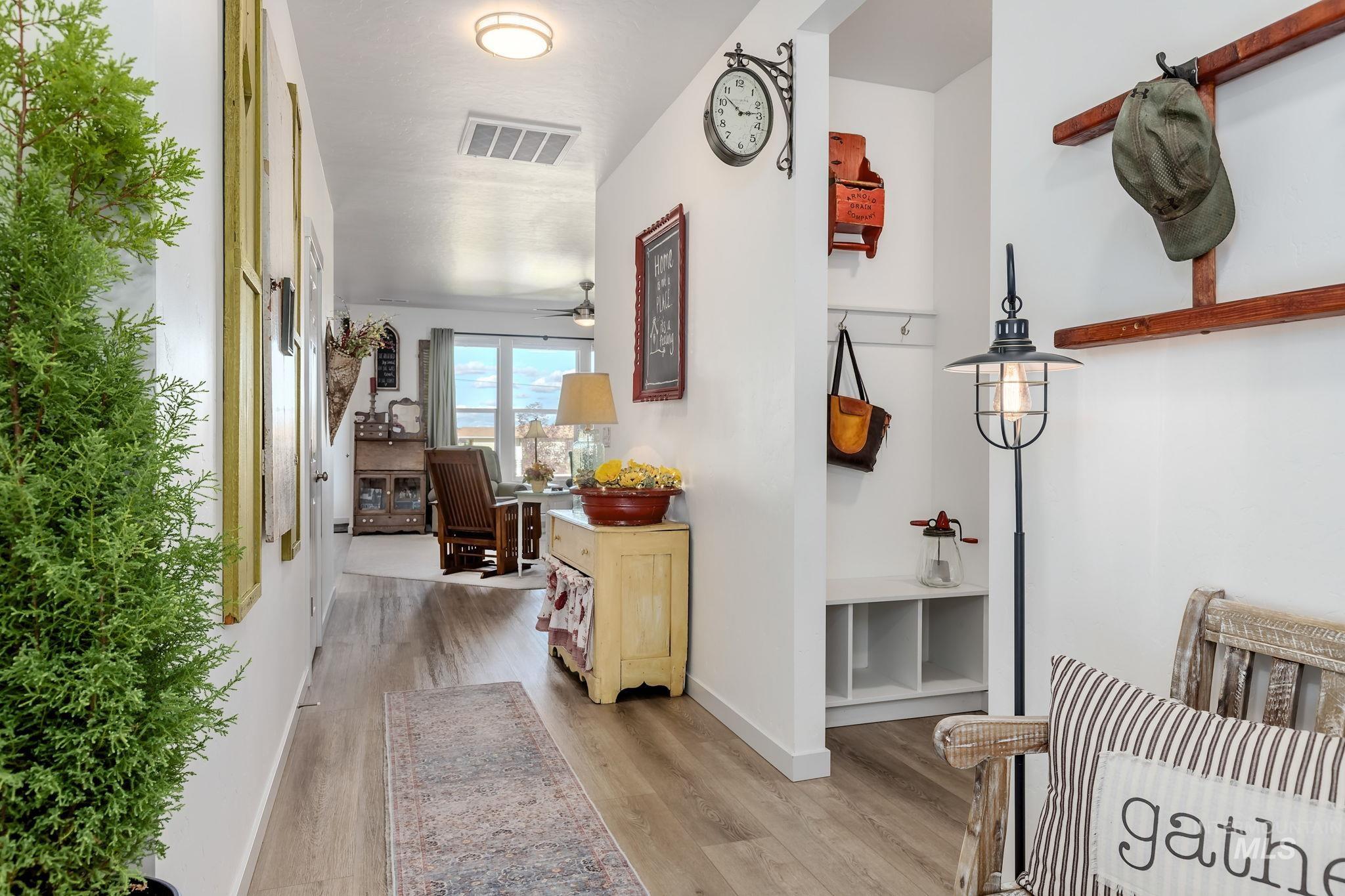 Corridor featuring light wood finished floors and baseboards