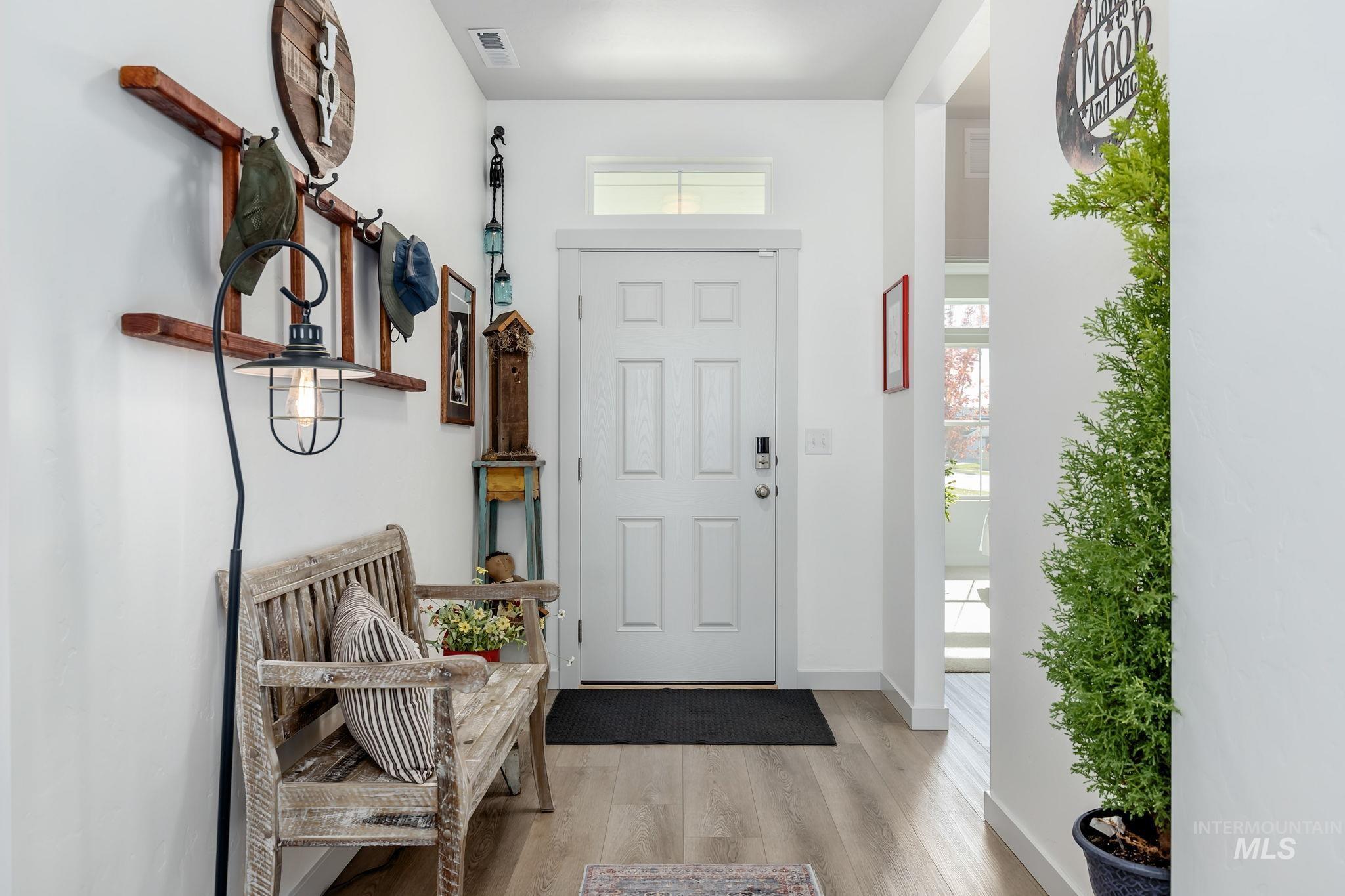 Foyer featuring light wood-type flooring and baseboards