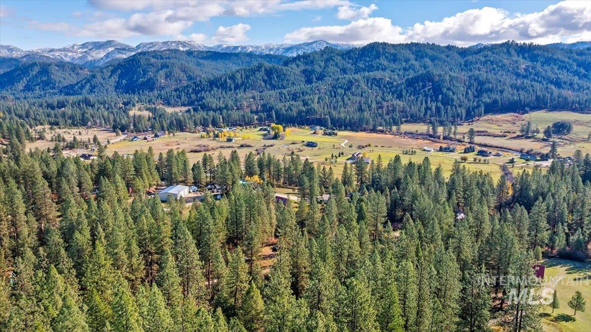 View of mountain backdrop featuring a heavily wooded area